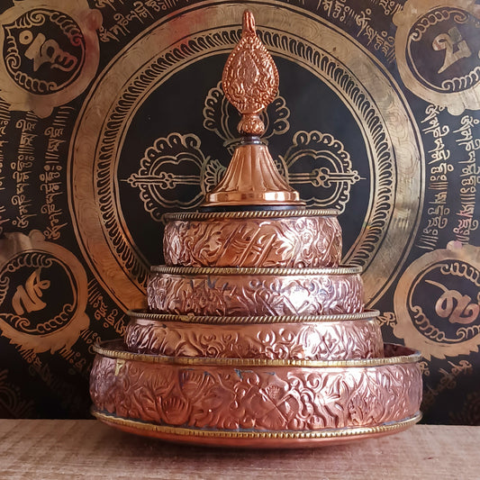Elevate your spiritual practice with this handmade large copper mandala offering set, crafted with traditional Tibetan artistry. In Tibetan Buddhism, offering a mandala symbolizes offering the entire universe—mountains, continents, precious substances, and realms—to the enlightened beings. Through this profound practice, one accumulates merit, wisdom, and spiritual clarity.