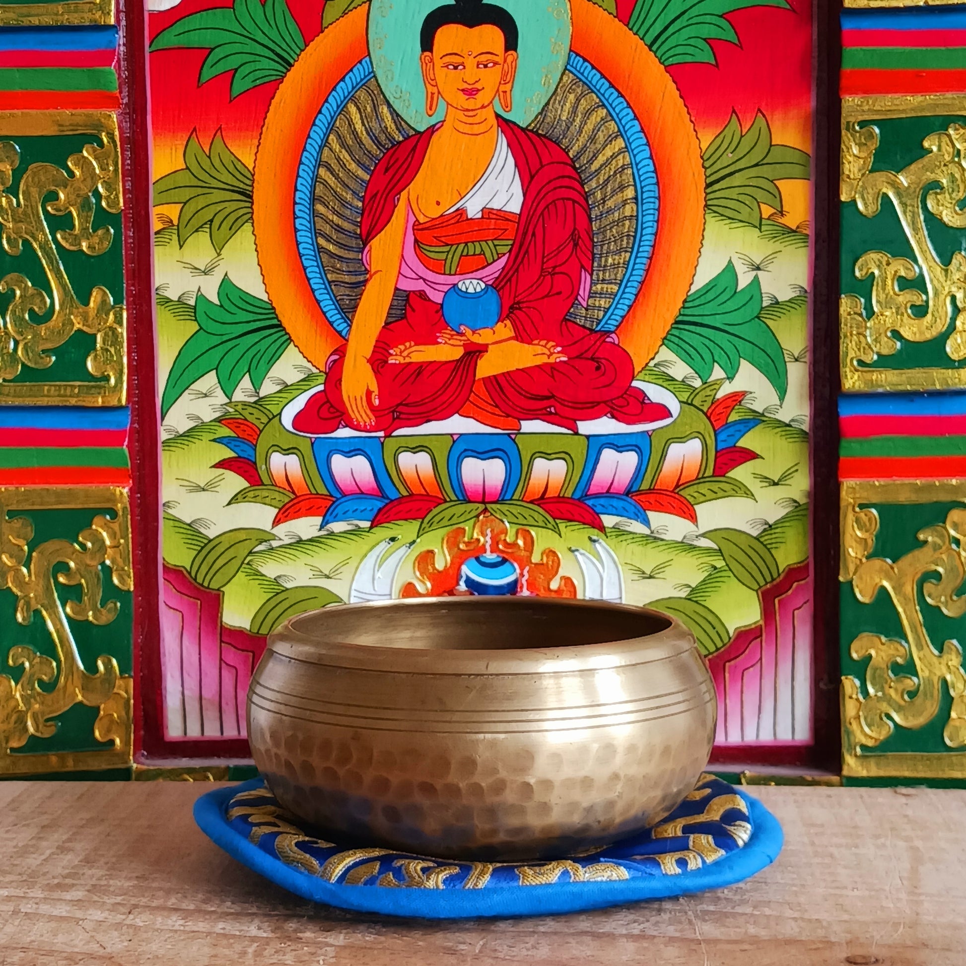 Elevate your practice with a hand-hammered Medicine Buddha singing bowl set, complete with cushion, striker, and symbolic gift box.