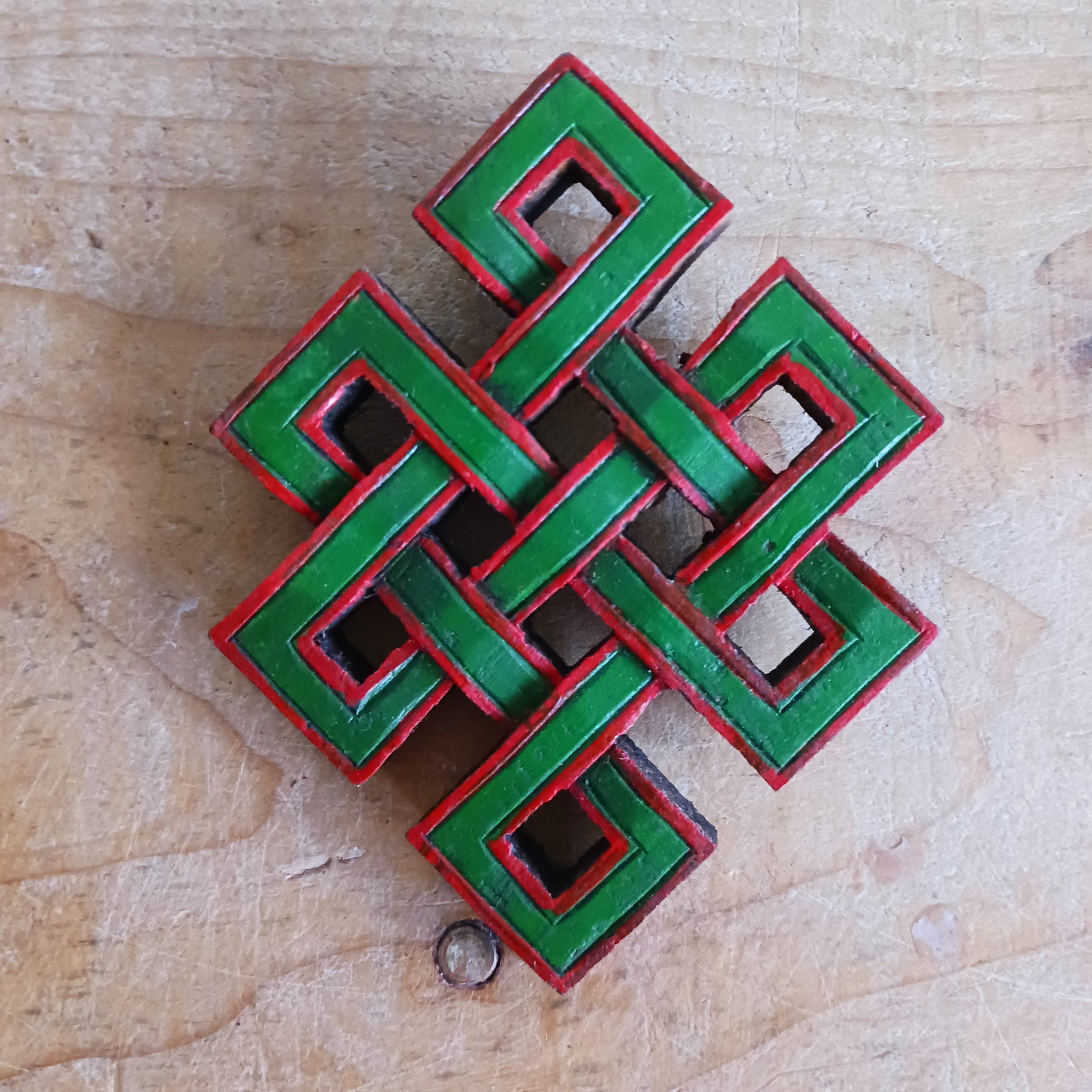 The Eternal (or Endless) Knot is one of the Eight auspicious symbols in Tibetan Buddhism.  Because the knot has no beginning and no end, the eternal knot symbolizes the endless wisdom and compassion of the Buddha.