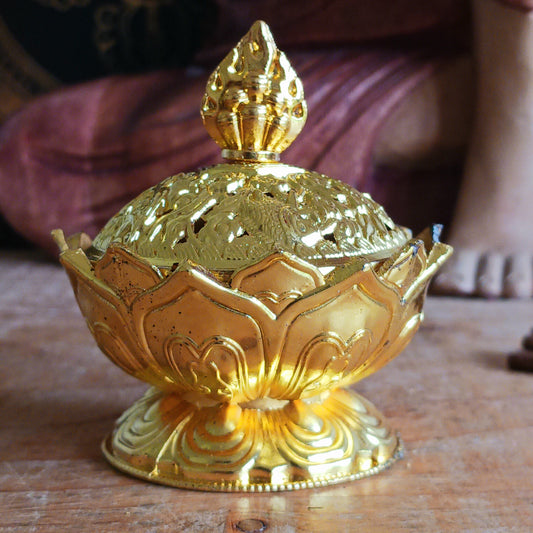 Bring serenity and beauty into your space with this elegant lotus-shaped incense burner, thoughtfully crafted to elevate your rituals and décor. The detailed lotus base symbolizes purity and enlightenment, while the ornate cap is adorned with traditional Tibetan Auspicious symbols, representing harmony, prosperity, and protection.
