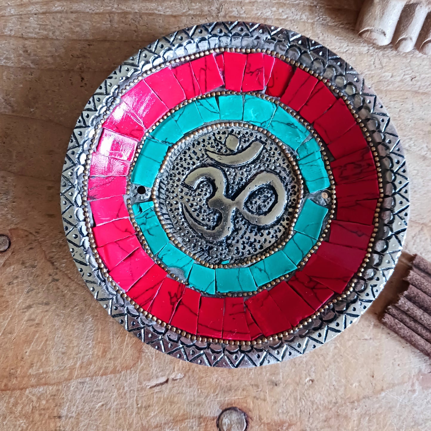 This handcrafted masterpiece transcends its function as a simple burner; it's a visual representation of the sacred syllable Om, a powerful symbol of peace, unity, and the interconnectedness of all things.