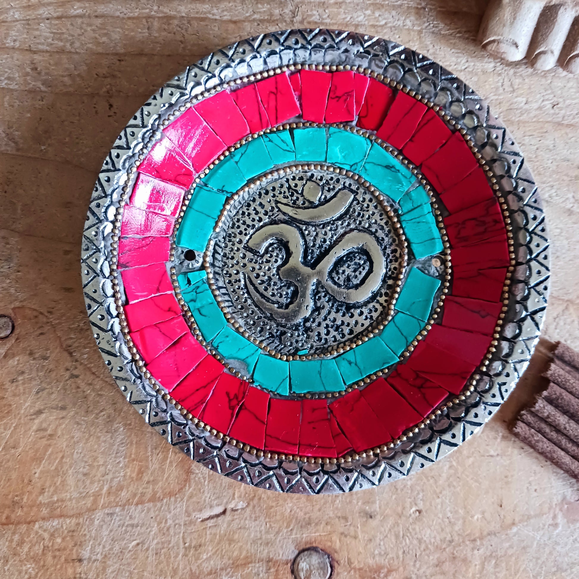 This handcrafted masterpiece transcends its function as a simple burner; it's a visual representation of the sacred syllable Om, a powerful symbol of peace, unity, and the interconnectedness of all things.