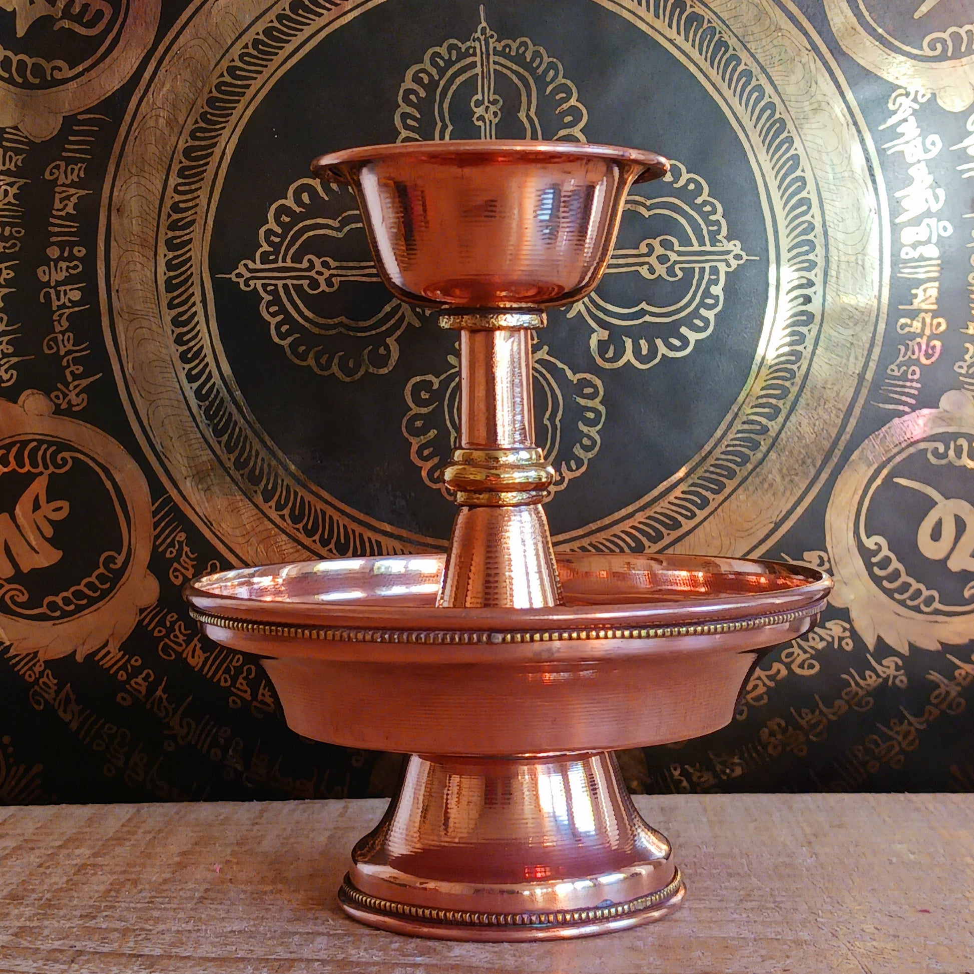 Immerse yourself in the sacred traditions of Tibetan Buddhism with this Traditional Tibetan Buddhist Copper Serkyem Set. Expertly crafted from high-quality copper, this ritual offering set is an essential tool used during pujas, deity offerings, and ceremonial practices.