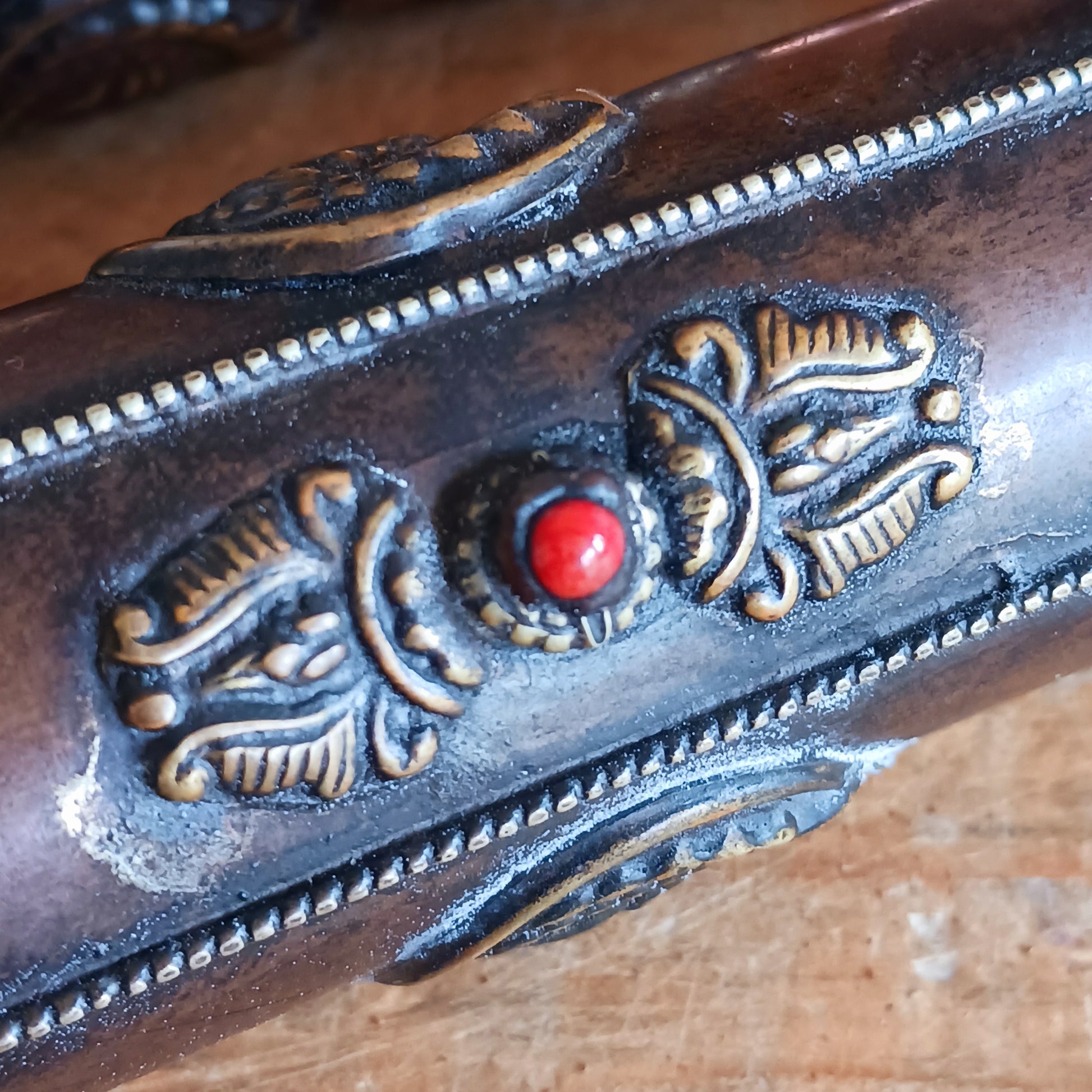 Introducing the Dorje Tibetan Incense Holder, a meticulously handcrafted ritual accessory designed to elevate your incense experience. This exquisite incense holder is not only a functional storage solution but also a captivating piece of art. Carefully crafted and adorned with brass dorjes and auspicious symbols, it exudes a sense of spiritual elegance.