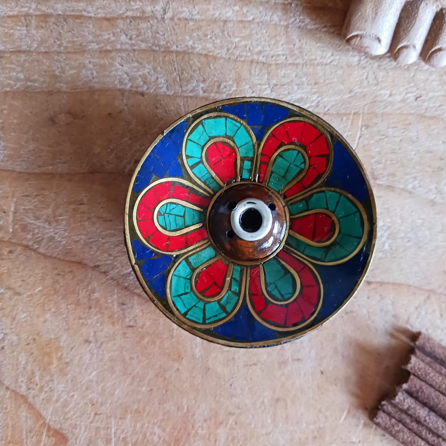 A beautiful Hand painted Tibetan Incense stick holder , Hand painted and ethically sourced this incense Holder is Perfect for the Larger Tibetan Incense it also has 4 small holes for Indian sticks.
