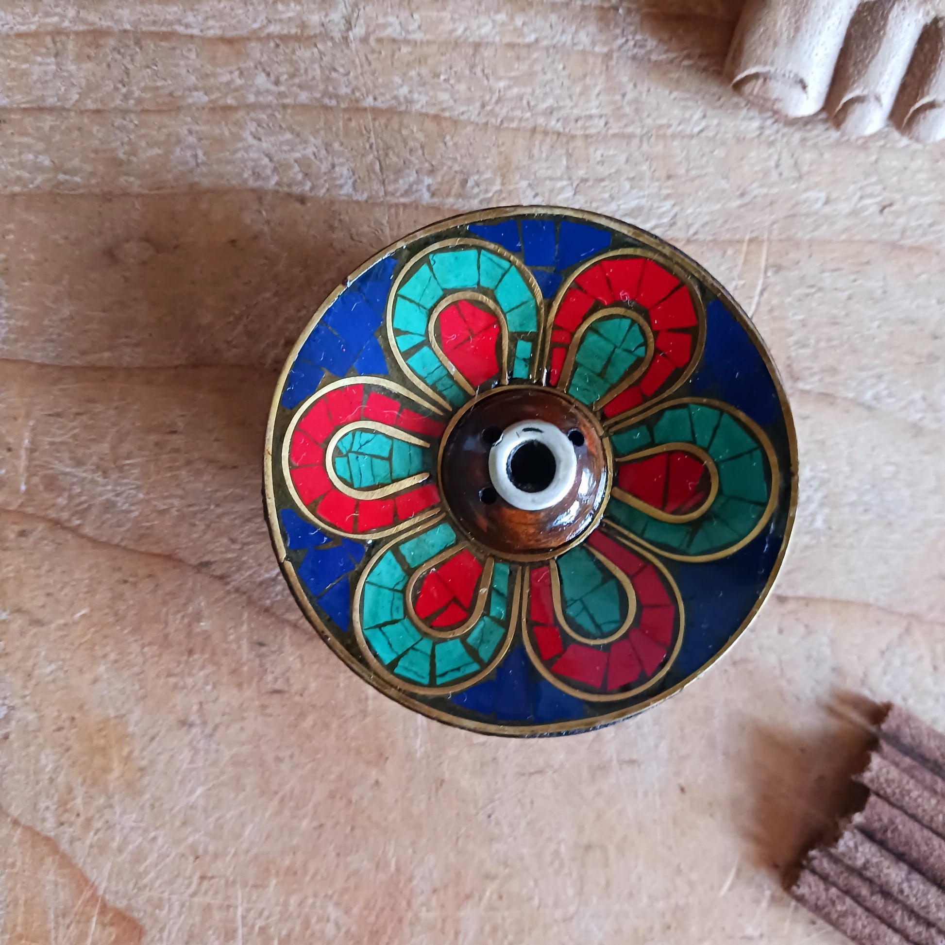 A beautiful Hand painted Tibetan Incense stick holder , Hand painted and ethically sourced this incense Holder is Perfect for the Larger Tibetan Incense it also has 4 small holes for Indian sticks.

