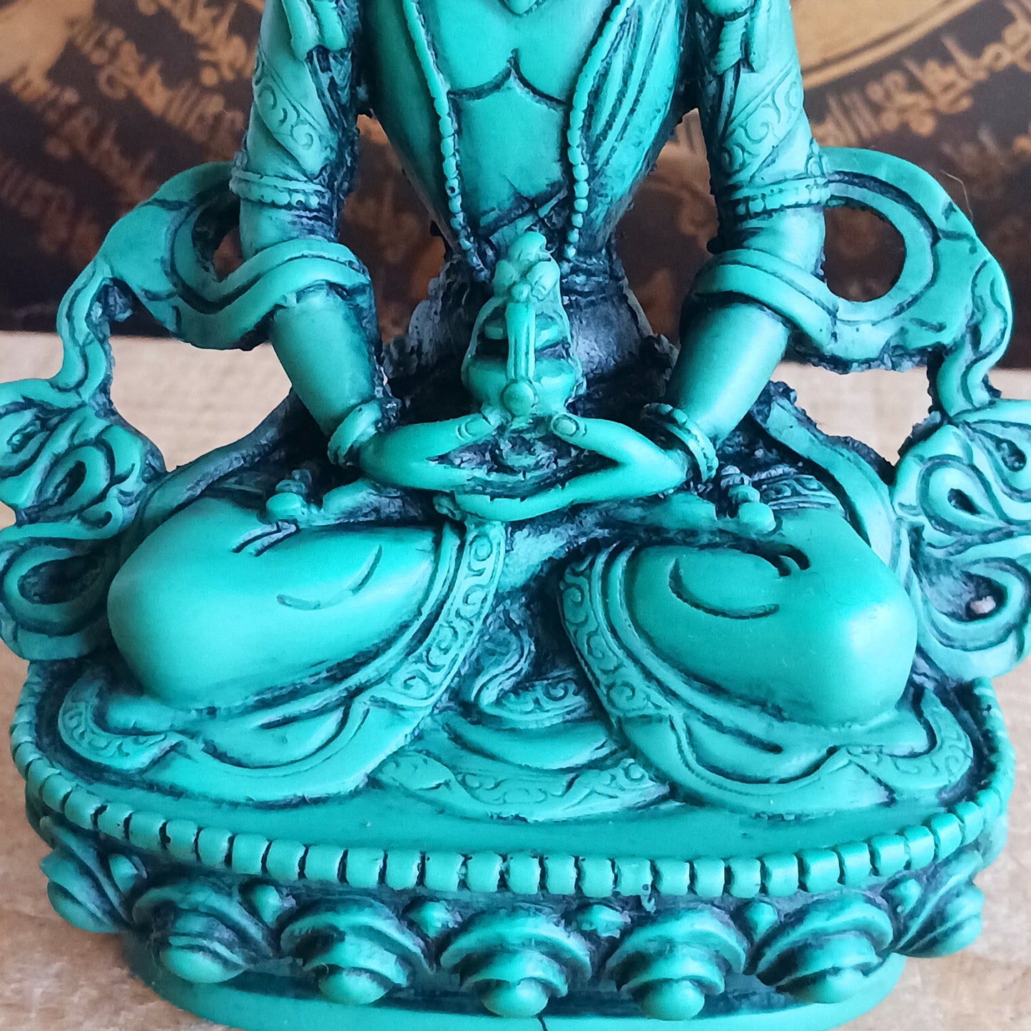White Tara is known for compassion, long life, healing and serenity and is shown here with her right hand in the varada mudra (blessing pose.) White Tara is distinct from the more commonly seen Green Tara. She is seated in a tranquil, full lotus position as opposed to Green Tara's one foot extended pose. These intricate resin statues are carefully handcrafted in Nepal.