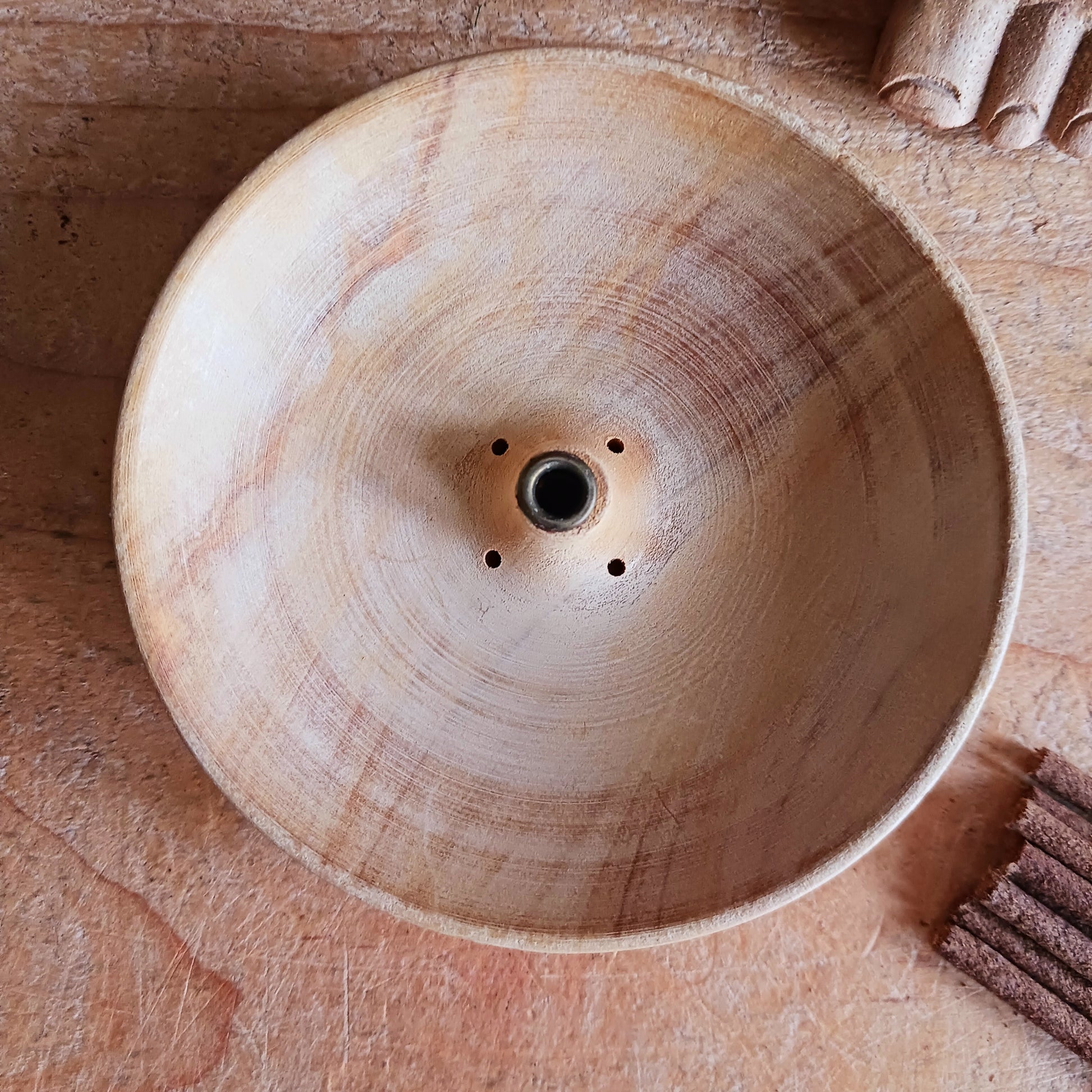 Bring a touch of Himalayan craftsmanship into your space with this beautifully hand-carved incense holder, crafted from a single piece of yellow wood sourced in Nepal. Each piece is skilfully shaped by local artisans, giving it its own natural character and charm.