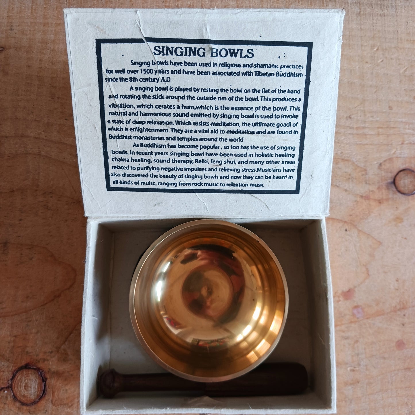 Discover the calming sound of mindfulness with this beautifully crafted Singing Bowl Gift Set. Ideal for beginners and children, the set includes a smooth, machine-made brass singing bowl that is easy to play, a wooden striker, and a soft cushion—all elegantly presented in a handmade Himalayan Lokta paper box.