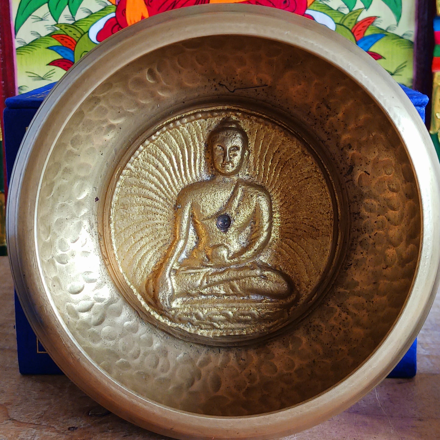 Elevate your practice with a hand-hammered Medicine Buddha singing bowl set, complete with cushion, striker, and symbolic gift box.