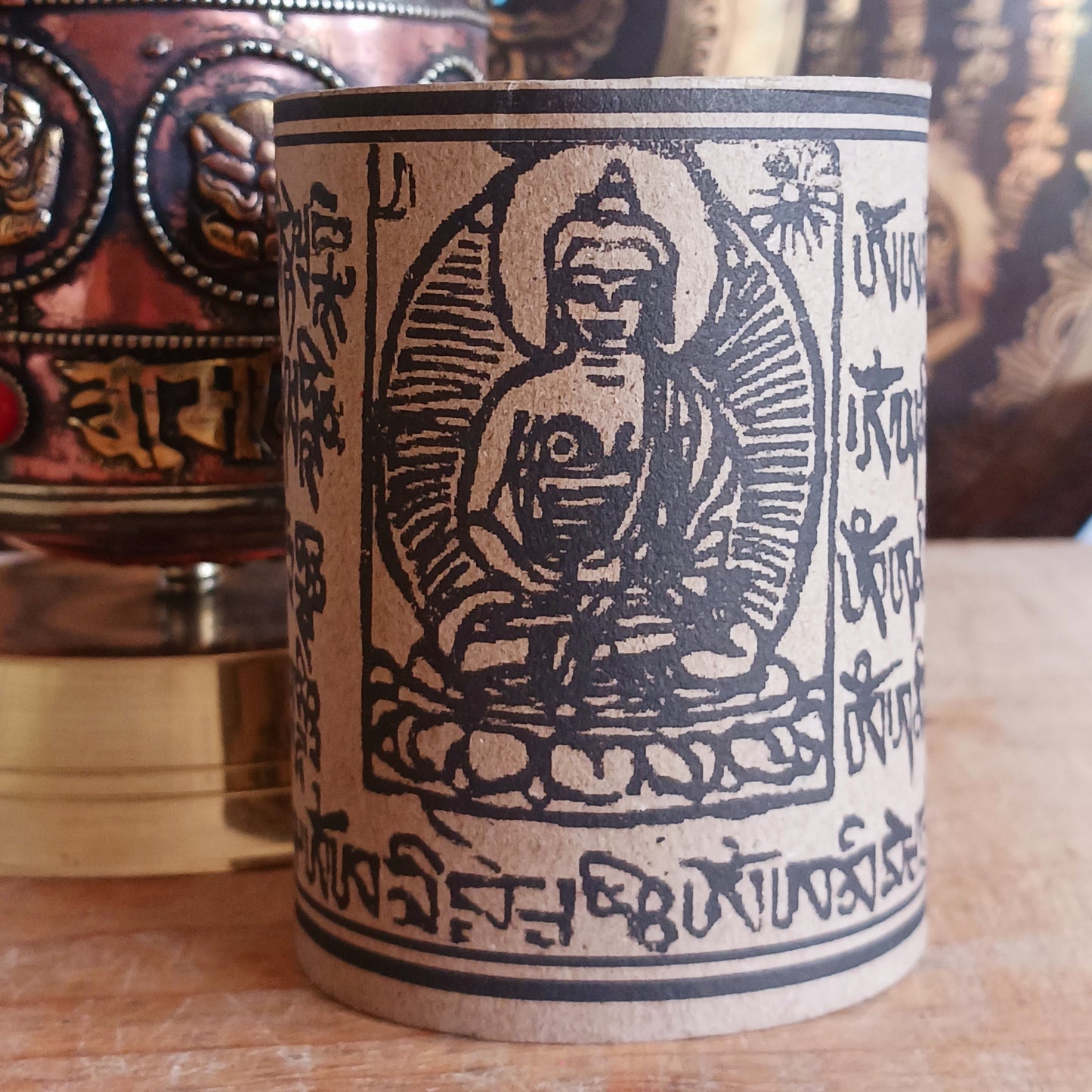 Invite blessings, clarity, and compassion into your space with this handcrafted metal table-top prayer wheel. Beautifully adorned with the Eight Auspicious Symbols, this sacred piece is both a devotional object and a stunning piece of spiritual art.