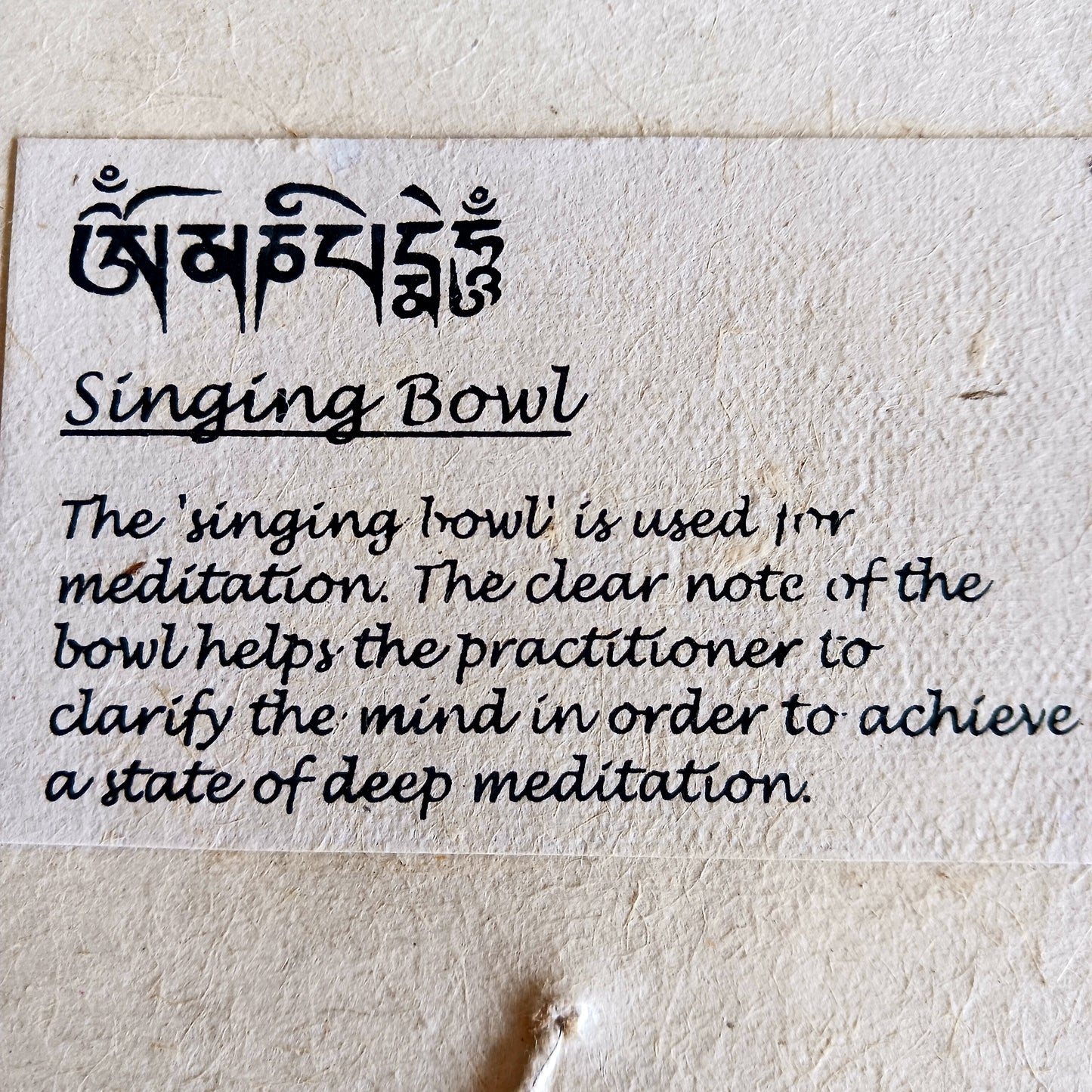 Discover the calming sound of mindfulness with this beautifully crafted Singing Bowl Gift Set. Ideal for beginners and children, the set includes a smooth, machine-made brass singing bowl that is easy to play, a wooden striker, and a soft cushion—all elegantly presented in a handmade Himalayan Lokta paper box.