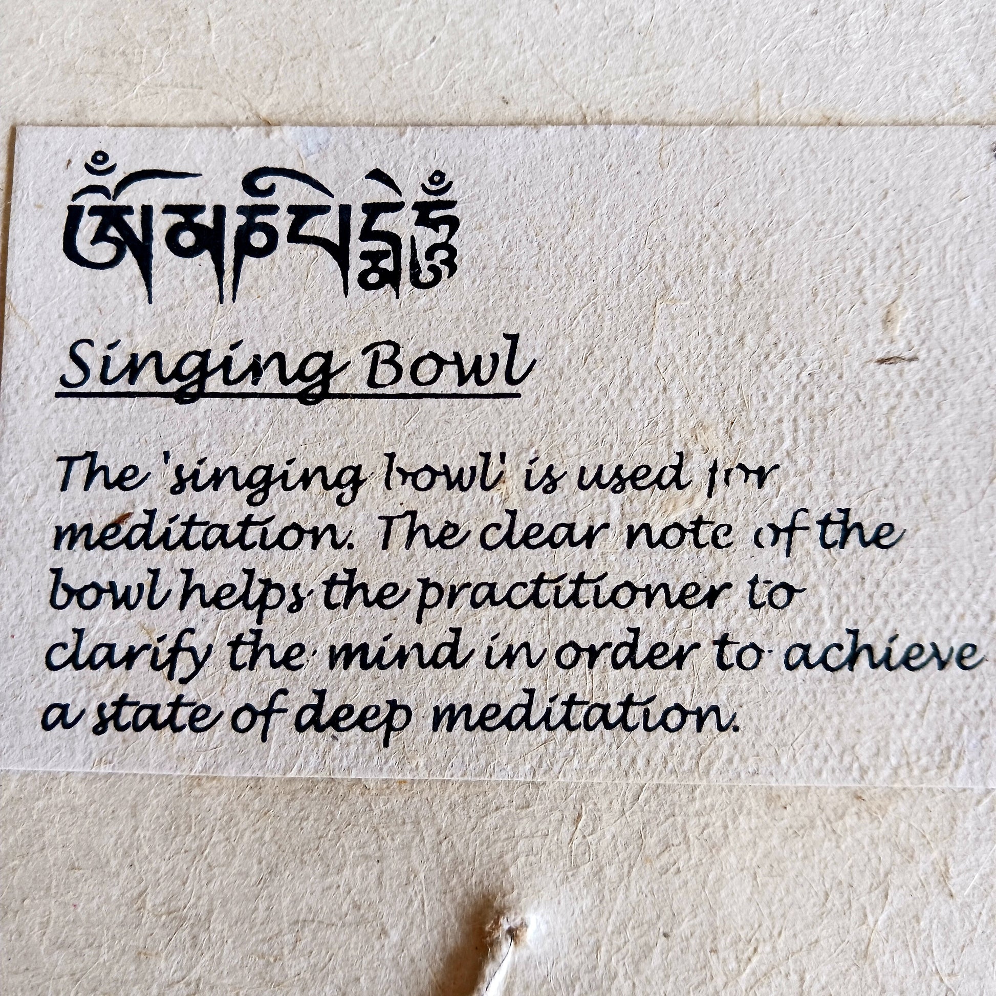 Discover the calming sound of mindfulness with this beautifully crafted Singing Bowl Gift Set. Ideal for beginners and children, the set includes a smooth, machine-made brass singing bowl that is easy to play, a wooden striker, and a soft cushion—all elegantly presented in a handmade Himalayan Lokta paper box.