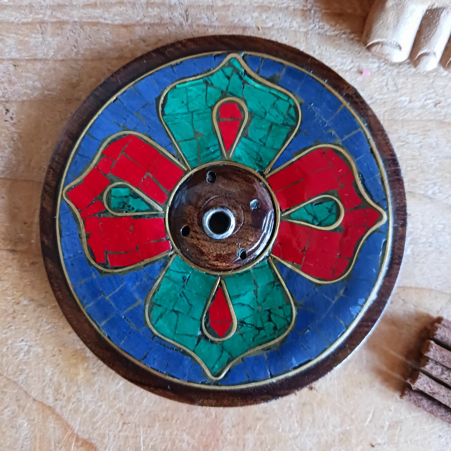 This Tibetan Wooden Incense Burner Stone Inlay is a hand-crafted incense holder, made with stunning craftsmanship in Nepal and imported under Fairtrade guidelines. This authentic piece of Buddhist art is 9 cm by 9 cm, made with carefully chosen wood and precious stone inlay of turquoise, coral and lapis.