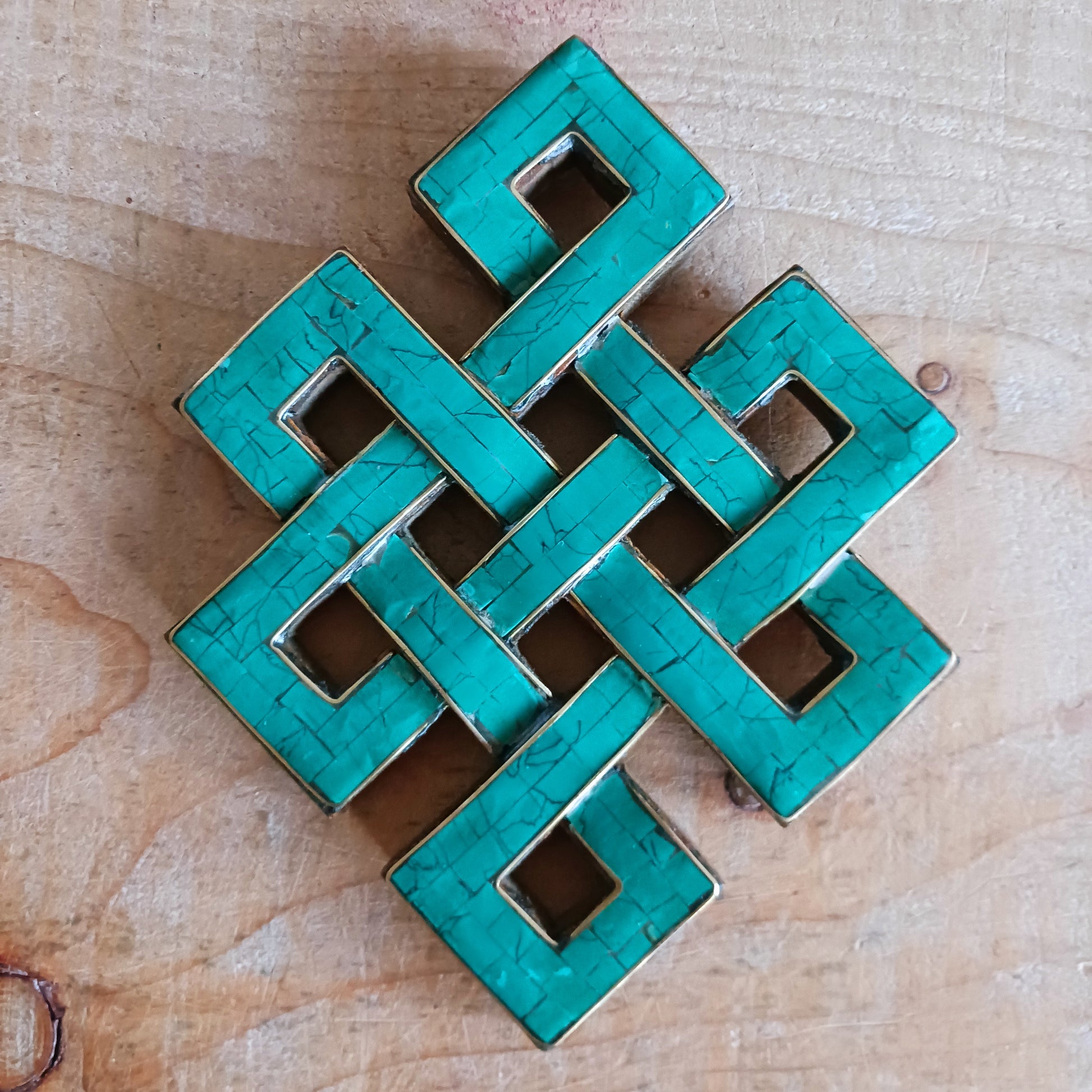 Add a touch of spiritual beauty and meaningful symbolism to your space with this hand-carved wooden Eternal (Endless) Knot wall décor. Carefully crafted by skilled artisans, each piece features turquoise stone chips inlaid into the carved wood, creating a stunning blend of natural texture and vibrant colour.