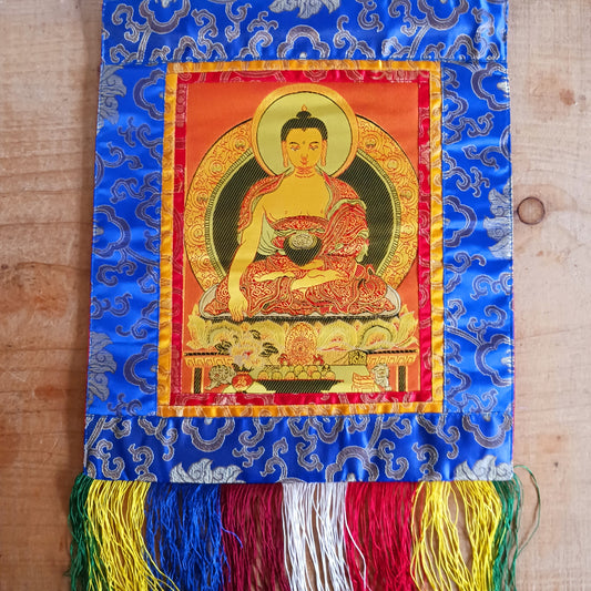 Bring serenity, beauty, and spiritual inspiration into any space with this Handmade Embroidered Buddha Thangka, crafted by skilled artisans in Nepal. Each piece is created using traditional techniques passed down through generations, featuring intricate embroidery and a rich brocade border that highlights the calm and compassionate presence of the Buddha.