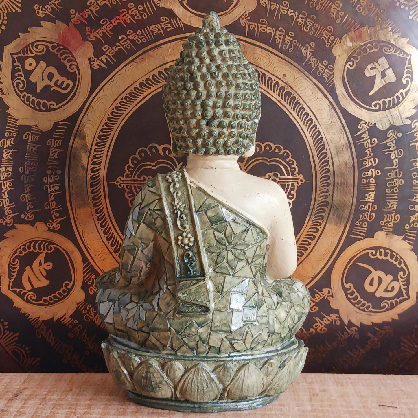 Invite peace and mindfulness into your space with this Buddha statuette, featuring a calming green mosaic pattern. Seated in the classic meditation pose with a tranquil expression, this modest figure is perfect for a shelf, home altar, or personal meditation corner. 