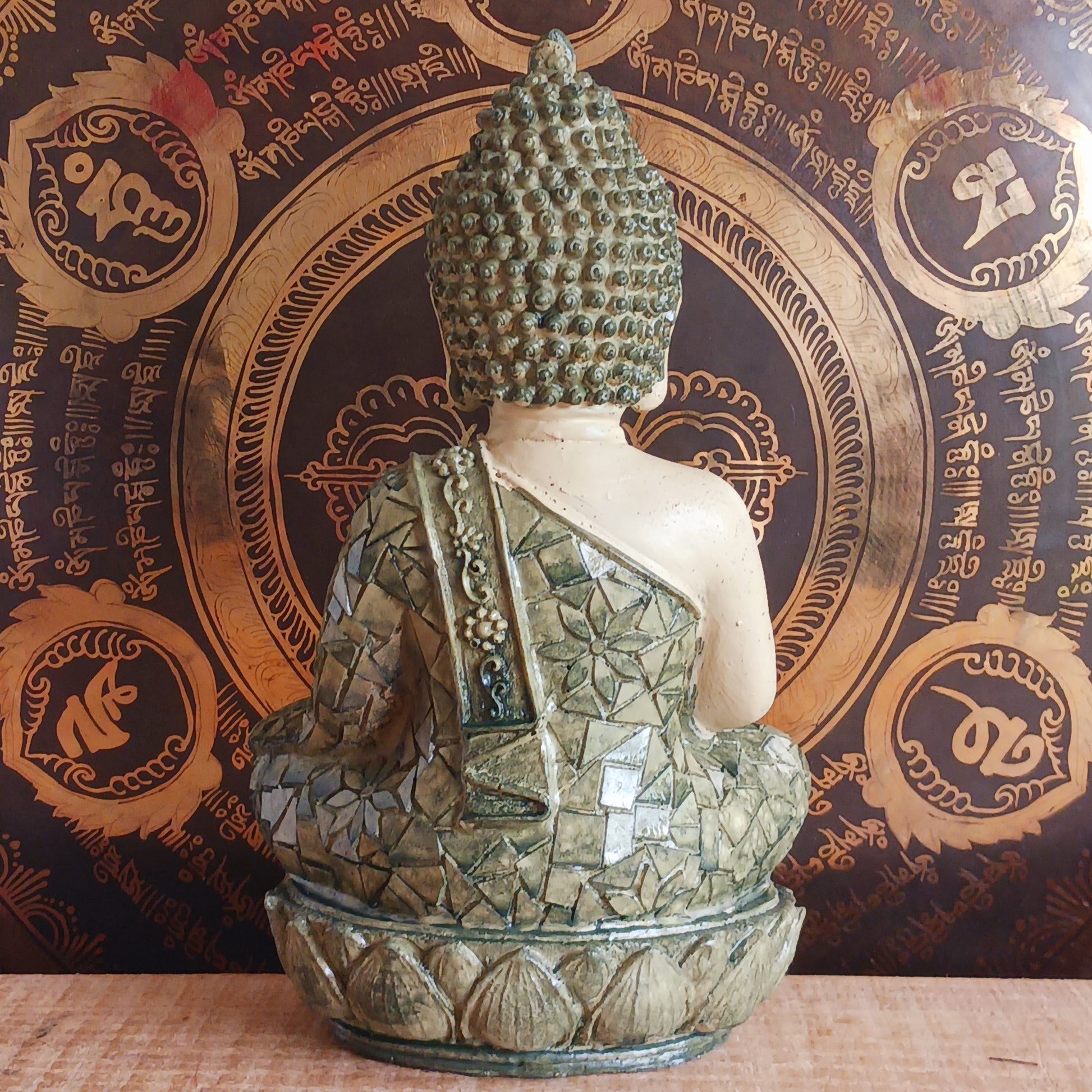 Invite peace and mindfulness into your space with this Buddha statuette, featuring a calming green mosaic pattern. Seated in the classic meditation pose with a tranquil expression, this modest figure is perfect for a shelf, home altar, or personal meditation corner. 