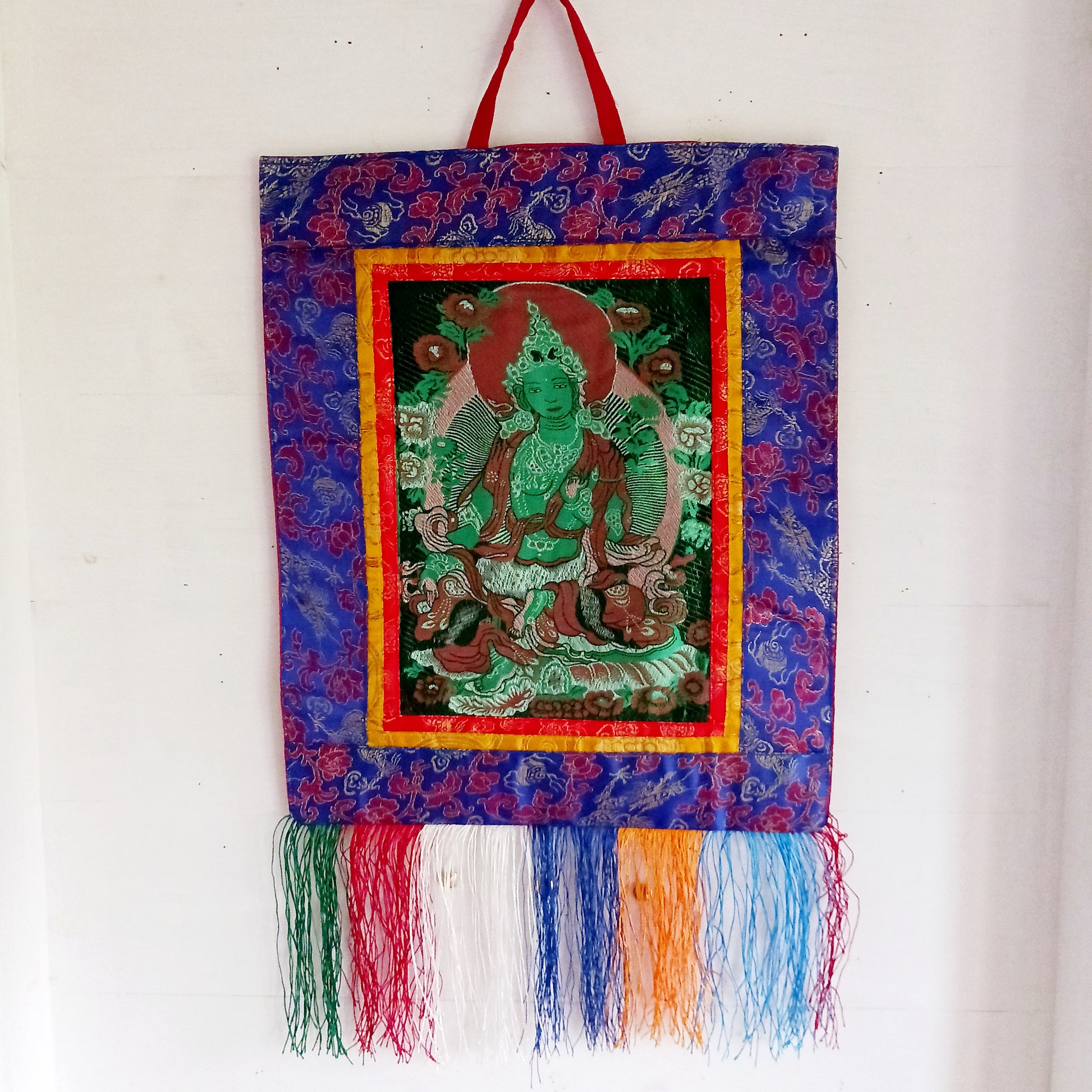 Bring serenity, beauty, and spiritual inspiration into any space with this Handmade Embroidered Green Tara Thangka, crafted by skilled artisans in Nepal. Each piece is created using traditional techniques passed down through generations, featuring intricate embroidery and a rich brocade border that highlights the calm and compassionate presence of Green Tara.