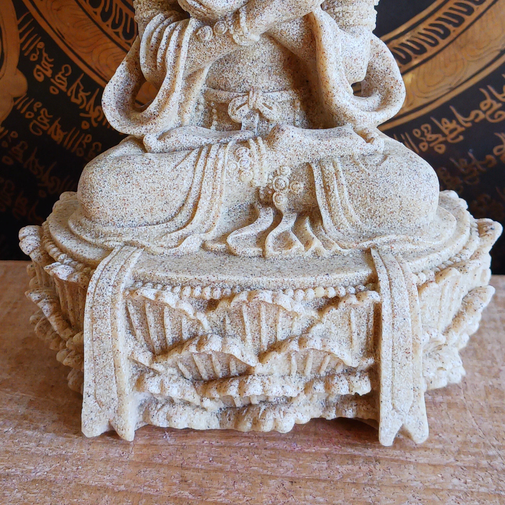 Elevate your sacred space with this beautifully crafted Sand Buddha Statue, inspired by traditional designs found in many Buddhist temples. Standing 17cm tall, this serene figure holds a Bell &amp; Dorje, symbolizing wisdom and compassion in perfect harmony.