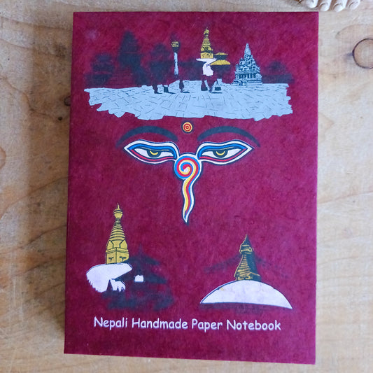 Experience the beauty of traditional Nepalese craftsmanship with this Buddha | Wisdom Eyes Notebook, handcrafted from natural Lokta paper. Each notebook features a durable hardback cover and approximately 50 pages of acid-free, eco-friendly Lokta paper, making it perfect for writing, sketching, journaling, or preserving important scripts for long periods.