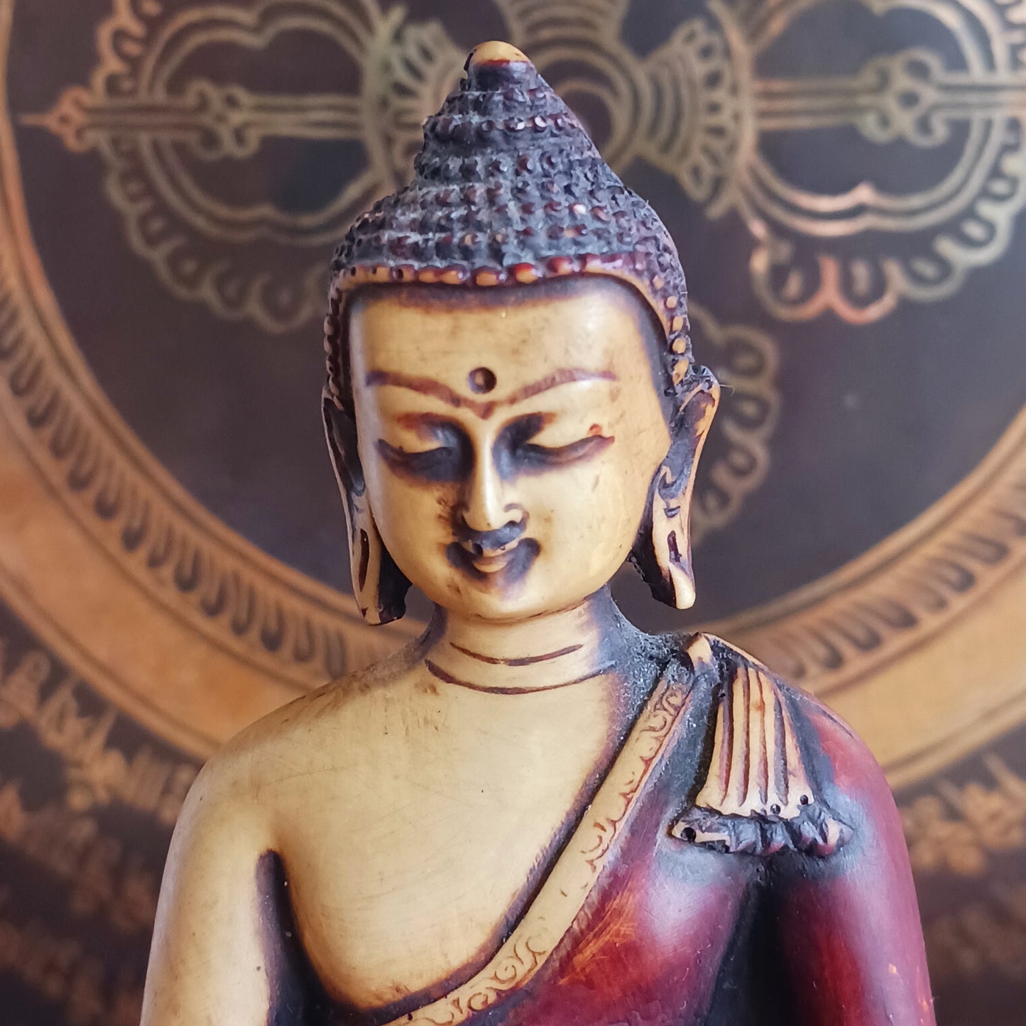 Invite healing, peace, and spiritual protection into your space with this beautifully crafted Medicine Buddha (Bhaisajya Tathagatta) statue in rich maroon and beige tones. Known as the Healing Buddha, Medicine Buddha embodies the power to cure the suffering of birth, sickness, and death. His luminous presence is traditionally described as shining like lapis lazuli, symbolizing purity and deep spiritual insight.