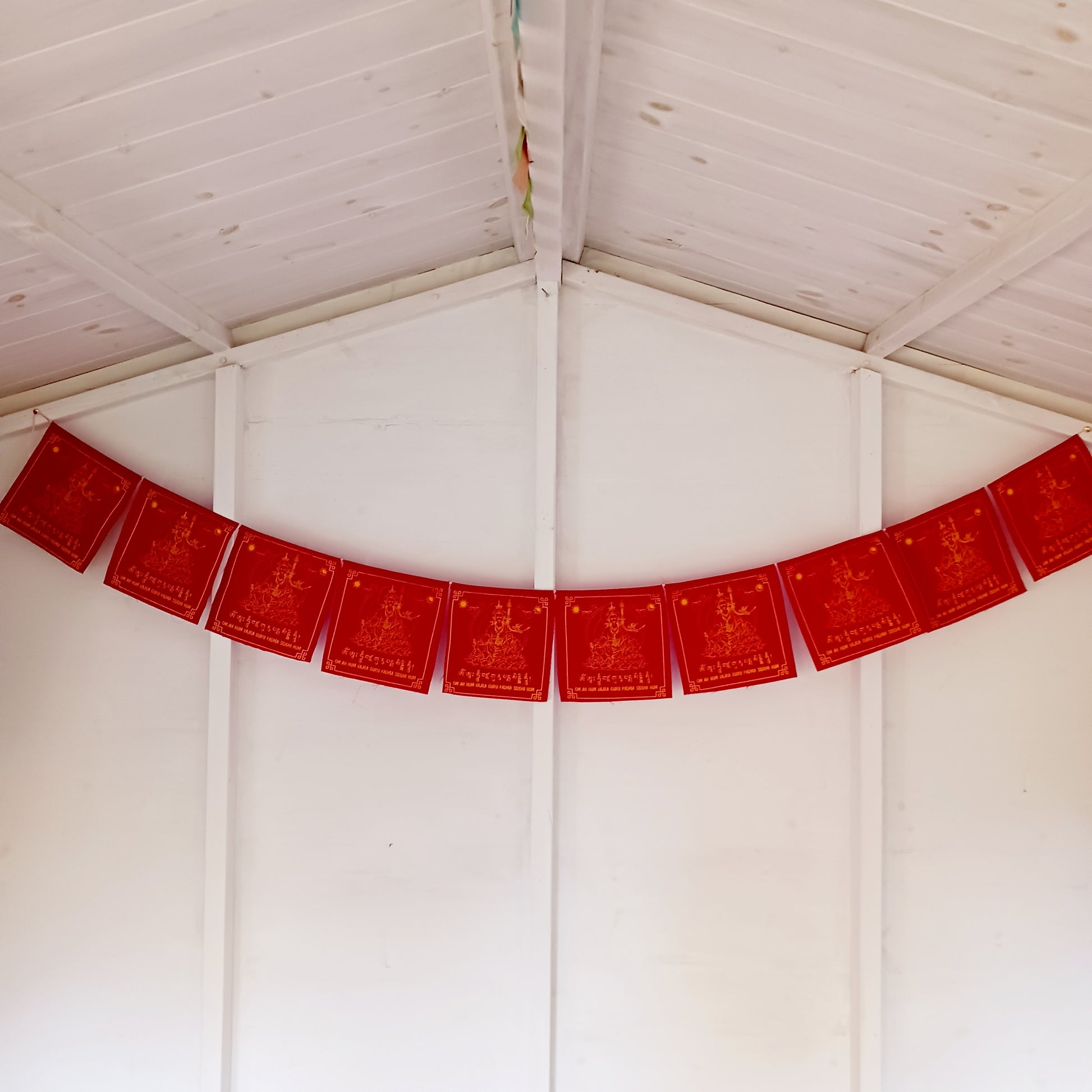 Invite the blessings of Guru Rinpoche, the “Precious Master,” into your home or sacred space with this beautiful set of prayer flags. Known as the founder of Tibetan Buddhism and an emanation of Buddha Amitabha, Guru Rinpoche brought the tantric teachings to Tibet in the 8th century, guiding countless beings on the path to enlightenment.