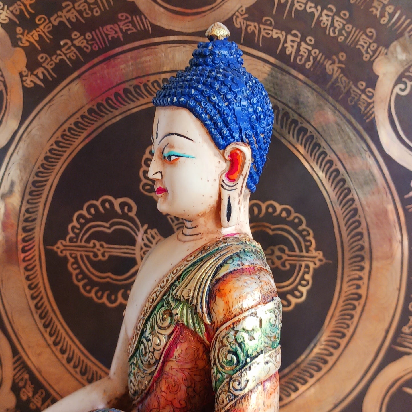 This exquisite Shakyamuni Buddha statue is crafted from a blend of clay and resin, then hand-painted by skilled artisans in Nepal. Using traditional thangka colours, each piece is meticulously detailed to match the authentic representations of Shakyamuni Buddha. The traditional painting process reflects deep spiritual symbolism, making this statue not only a beautiful decorative item but also a meaningful spiritual artifact. Perfect for your altar, meditation space, or as a unique cultural gift.