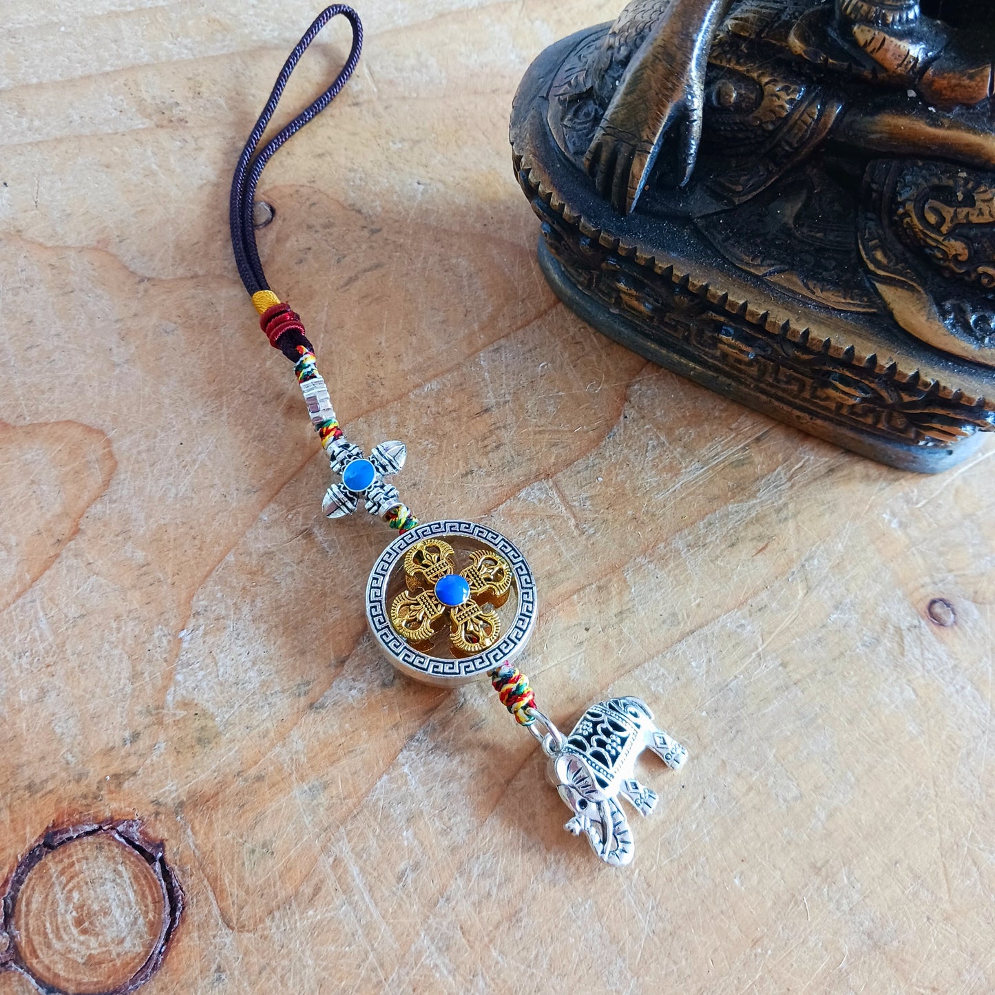 Bring peace, protection, and powerful symbolism wherever you go with this Buddhist protective pendant. Featuring the Double Dorje, a sacred symbol of stability, strength, and protection from fear, and an Elephant, representing the transformation of desire into mindfulness and contentment, this pendant is a meaningful accessory for your car, home, bag, or key ring. Crafted with intention, it's a perfect reminder of your inner strength and spiritual focus.