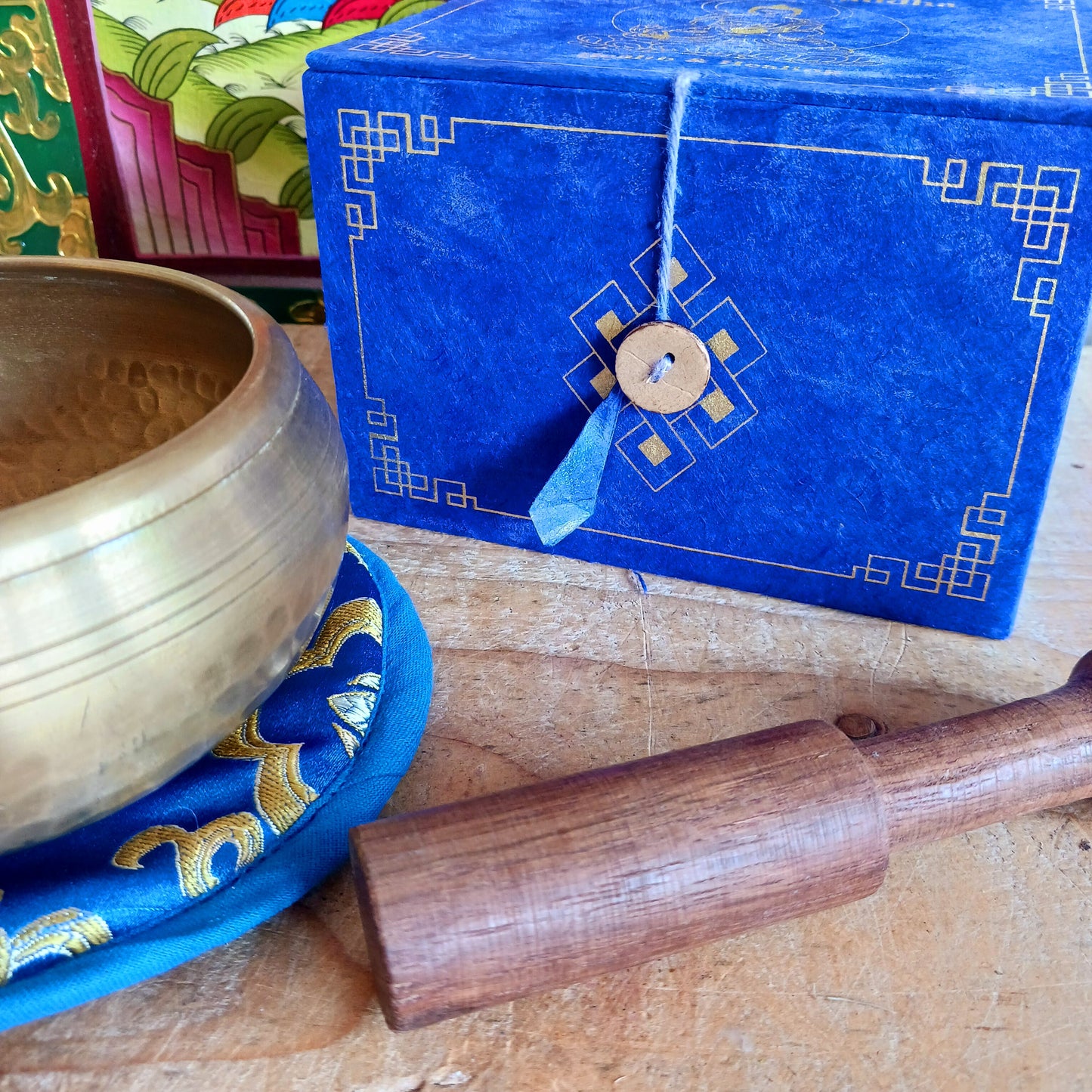 Elevate your practice with a hand-hammered Medicine Buddha singing bowl set, complete with cushion, striker, and symbolic gift box.