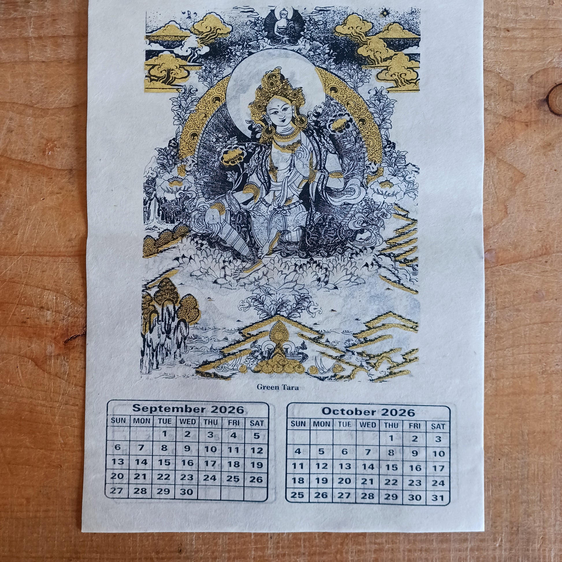 Bring the beauty, wisdom, and serenity of Buddhist art into your home with this handmade Lokta paper wall calendar, featuring seven revered Buddhist deities illustrated in traditional Thangka style. Each page showcases one of the following sacred figures:
