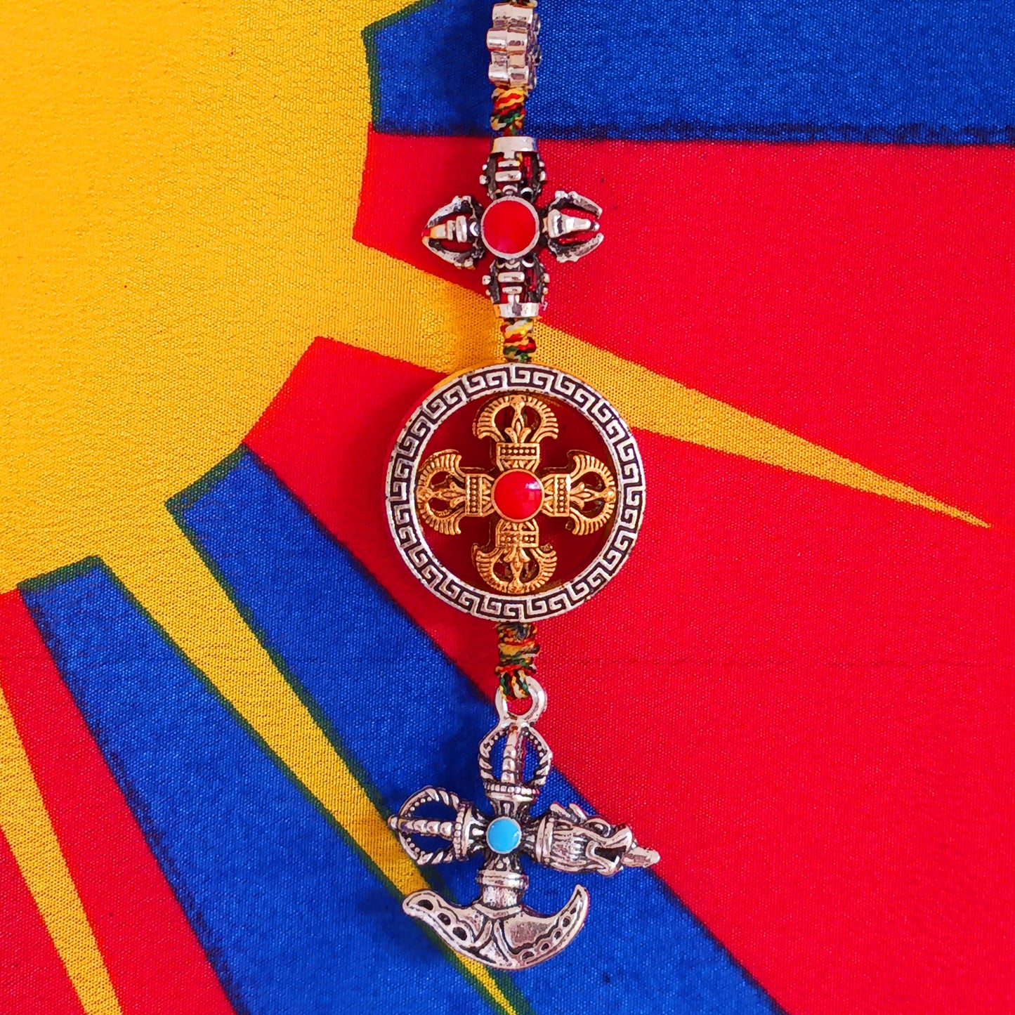 Bring the power of ancient Tibetan symbolism into your daily life with this handcrafted Buddhist protective pendant. Featuring the Double Dorje, a symbol of unwavering stability and protection from fear, and the Kartika, a ritual blade representing the cutting away of ignorance and attachment, this versatile charm can be hung in your car, placed in your home, or attached to your bag or key ring