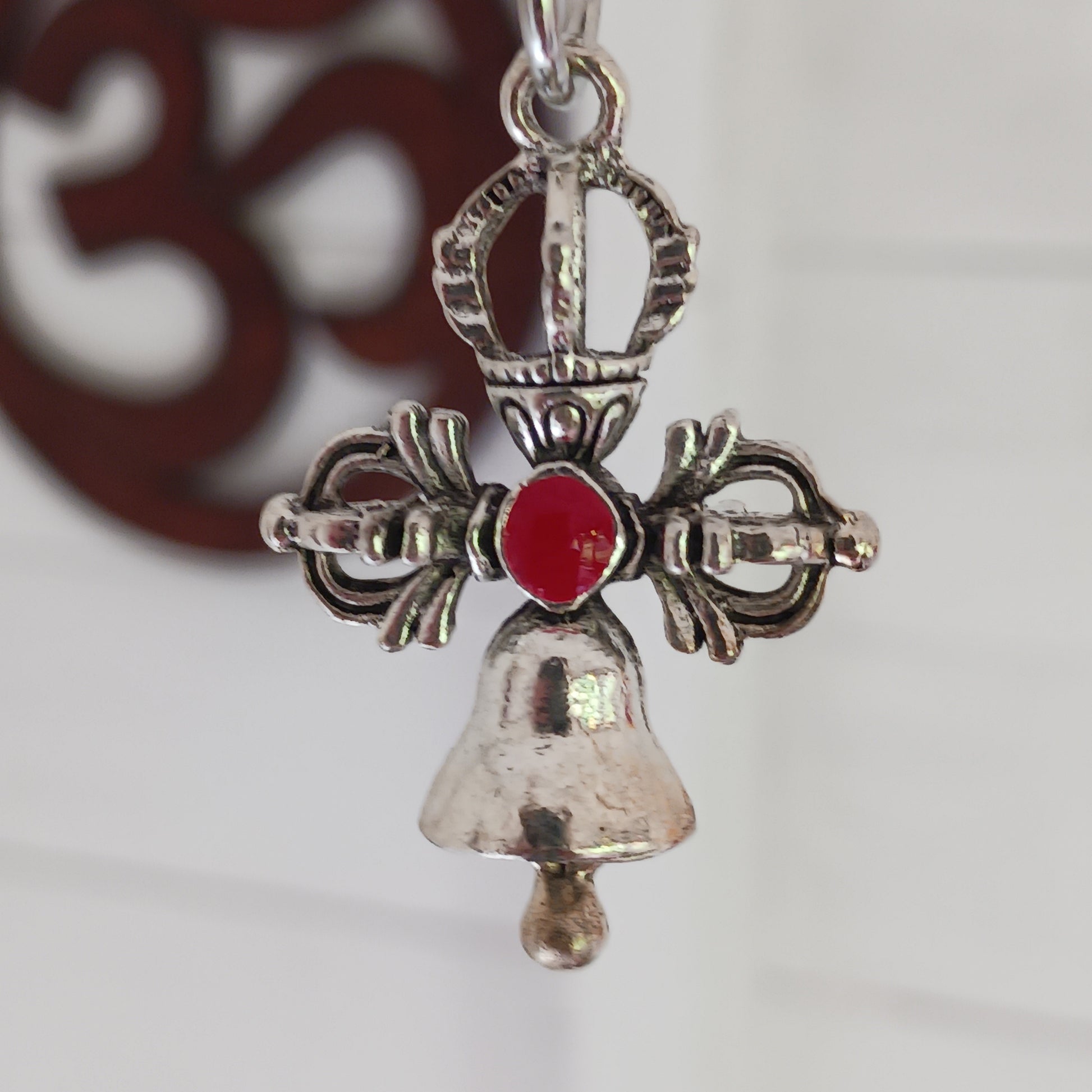 Bring peace, protection, and wisdom wherever you go with this handcrafted Buddhist protective pendant. Featuring the powerful Double Dorje, a symbol of stability and fearlessness, and the Bell, representing wisdom and the understanding of emptiness, this sacred charm is ideal for your car, home, bag, or key ring. Whether you're seeking spiritual grounding or a meaningful gift, this pendant serves as a constant reminder of balance and enlightenment in daily life.