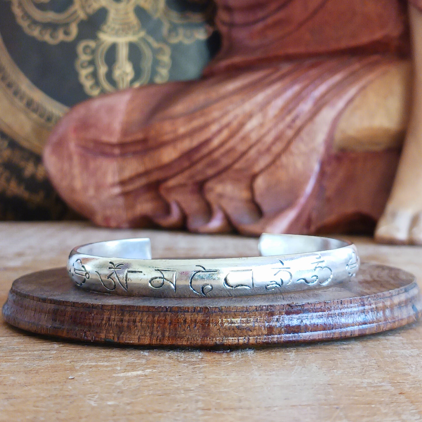 Experience the spiritual elegance of our Tibetan White Metal Bangles, intricately etched with the sacred Buddhist mantra, Om Mani Padme Hum. Each bangle is handcrafted with meticulous detail, reflecting traditional Tibetan artistry. Perfect as a meaningful gift, each piece comes beautifully presented in a traditional Tibetan pouch, making it ideal for meditation, mindfulness, or as a unique accessory that carries a message of peace and compassion.