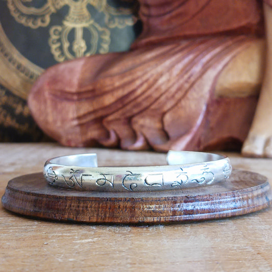 Experience the spiritual elegance of our Tibetan White Metal Bangles, intricately etched with the sacred Buddhist mantra, Om Mani Padme Hum. Each bangle is handcrafted with meticulous detail, reflecting traditional Tibetan artistry. Perfect as a meaningful gift, each piece comes beautifully presented in a traditional Tibetan pouch, making it ideal for meditation, mindfulness, or as a unique accessory that carries a message of peace and compassion.
