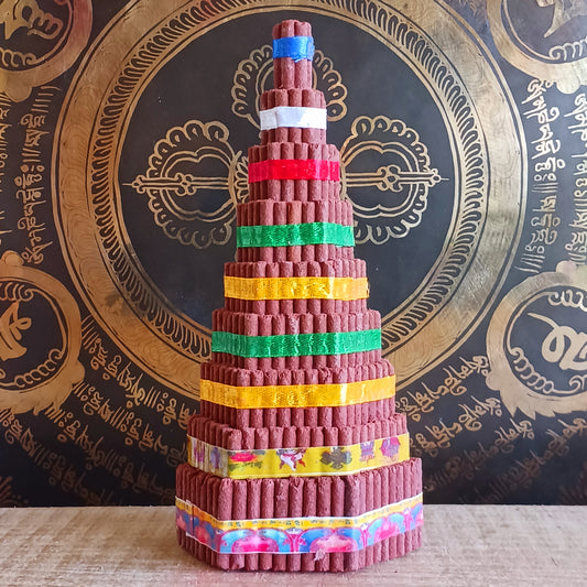 Bring authentic Himalayan tradition to your sacred space with this Buddhist Shrine Tibetan Incense Torma. Handmade in Nepal using the ancient art of incense crafting, each torma is carefully formed from a blend of herbs, fragrant woods, and spices.