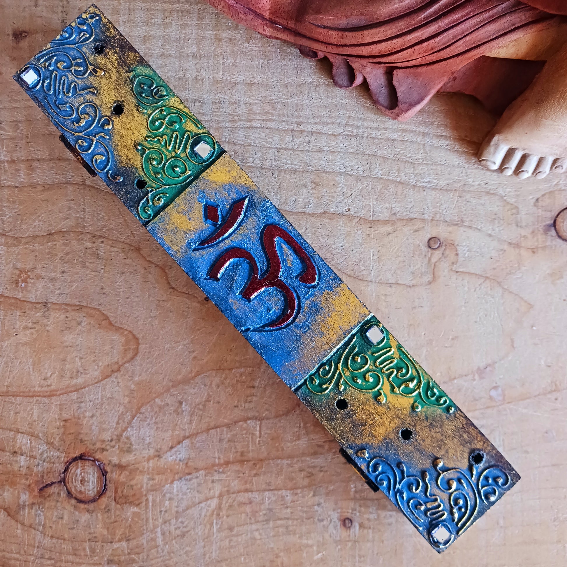 Create a calm, aromatic atmosphere in your home with this beautifully handcrafted OM incense holder. Made from responsibly sourced wood, this unique piece features a delicately hand-carved OM symbol, making it both a functional incense burner and a decorative spiritual accent.