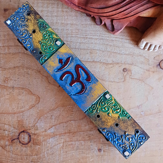 Create a calm, aromatic atmosphere in your home with this beautifully handcrafted OM incense holder. Made from responsibly sourced wood, this unique piece features a delicately hand-carved OM symbol, making it both a functional incense burner and a decorative spiritual accent.