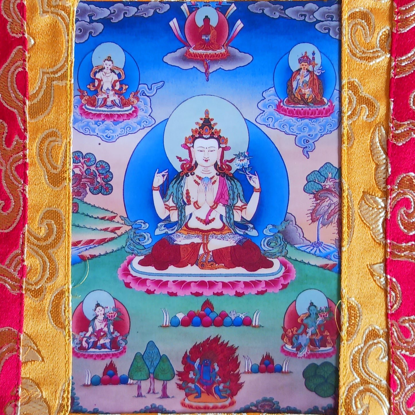 Shop this small Chenrezig thangka with silk brocade frame – a sacred image of Avalokiteshvara, the Bodhisattva of Compassion. Perfect for altars or gifting.