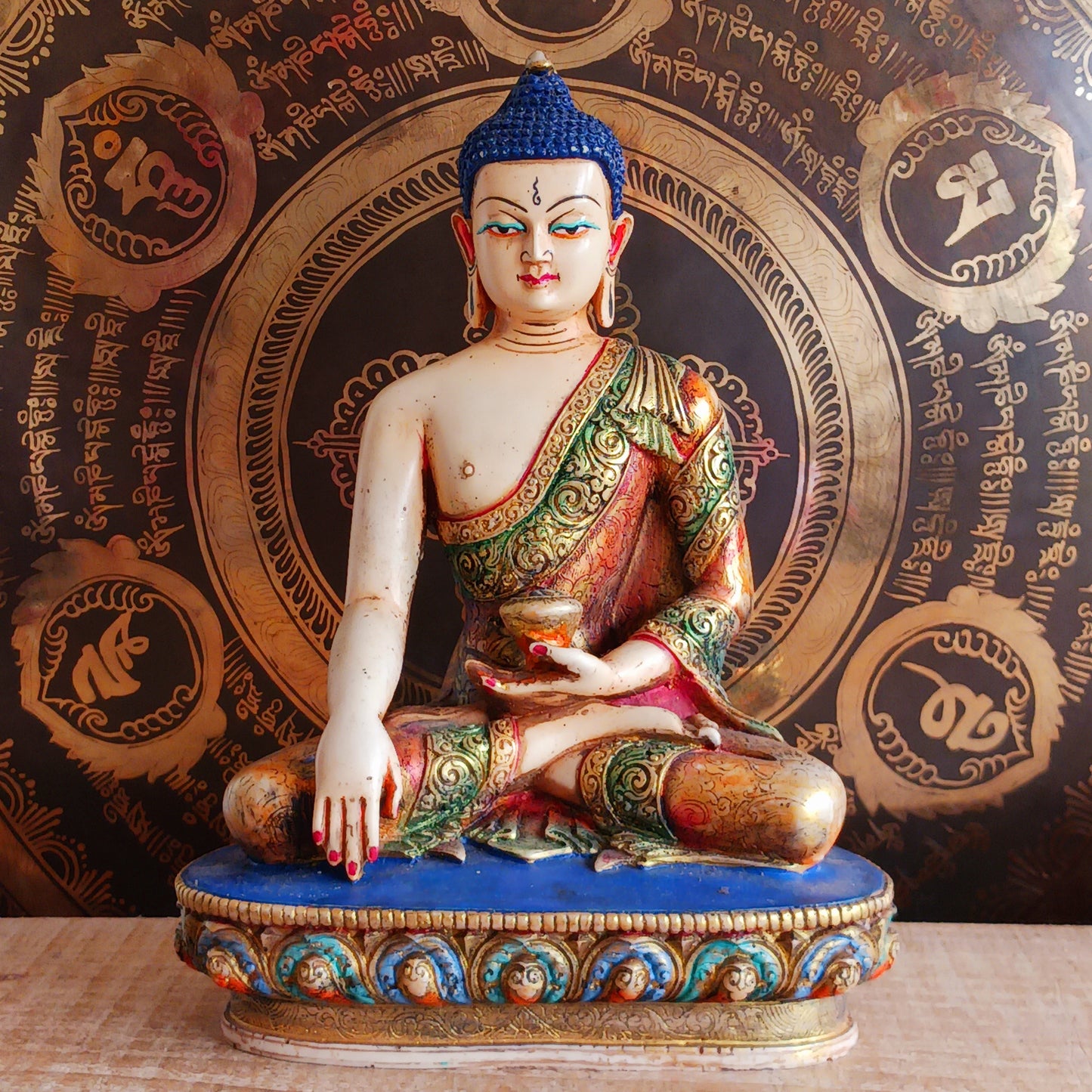 This exquisite Shakyamuni Buddha statue is crafted from a blend of clay and resin, then hand-painted by skilled artisans in Nepal. Using traditional thangka colours, each piece is meticulously detailed to match the authentic representations of Shakyamuni Buddha. The traditional painting process reflects deep spiritual symbolism, making this statue not only a beautiful decorative item but also a meaningful spiritual artifact. Perfect for your altar, meditation space, or as a unique cultural gift.
