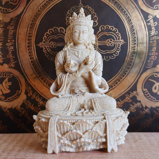 Elevate your sacred space with this beautifully crafted Sand Buddha Statue, inspired by traditional designs found in many Buddhist temples. Standing 17cm tall, this serene figure holds a Bell &amp; Dorje, symbolizing wisdom and compassion in perfect harmony.