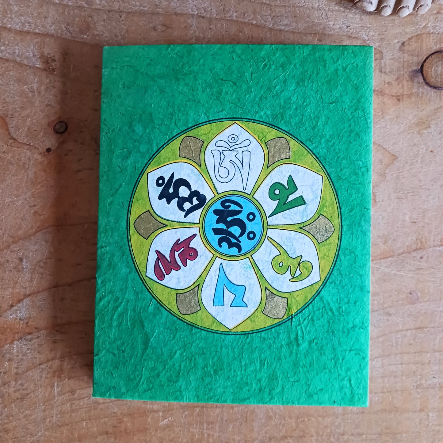 Discover the beauty of traditional craftsmanship with our Handmade Om Mani Notebooks. Each notebook features a durable hard-back cotton cover adorned with the sacred Om Mani design, symbolising wisdom and compassion.