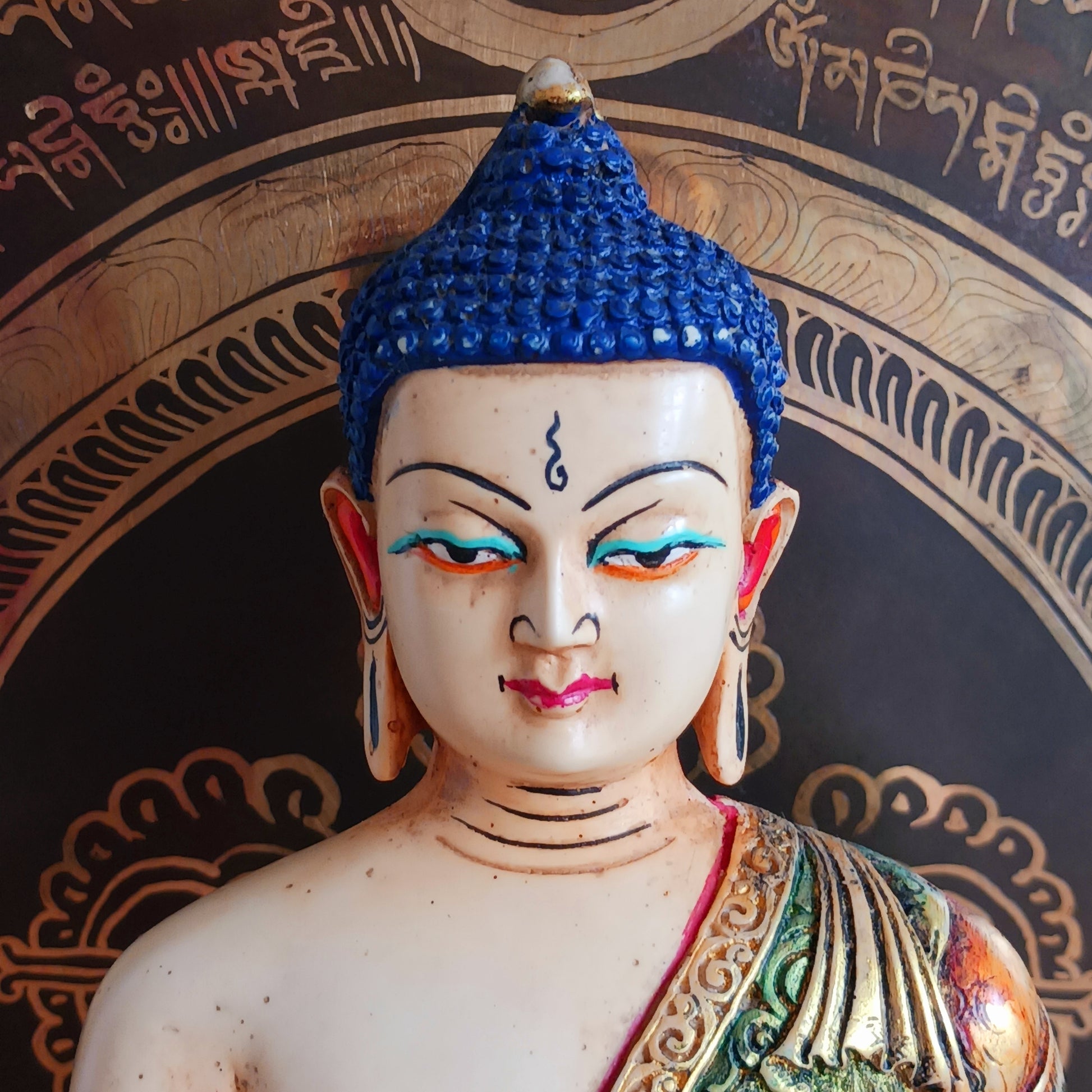 This exquisite Shakyamuni Buddha statue is crafted from a blend of clay and resin, then hand-painted by skilled artisans in Nepal. Using traditional thangka colours, each piece is meticulously detailed to match the authentic representations of Shakyamuni Buddha. The traditional painting process reflects deep spiritual symbolism, making this statue not only a beautiful decorative item but also a meaningful spiritual artifact. Perfect for your altar, meditation space, or as a unique cultural gift.
