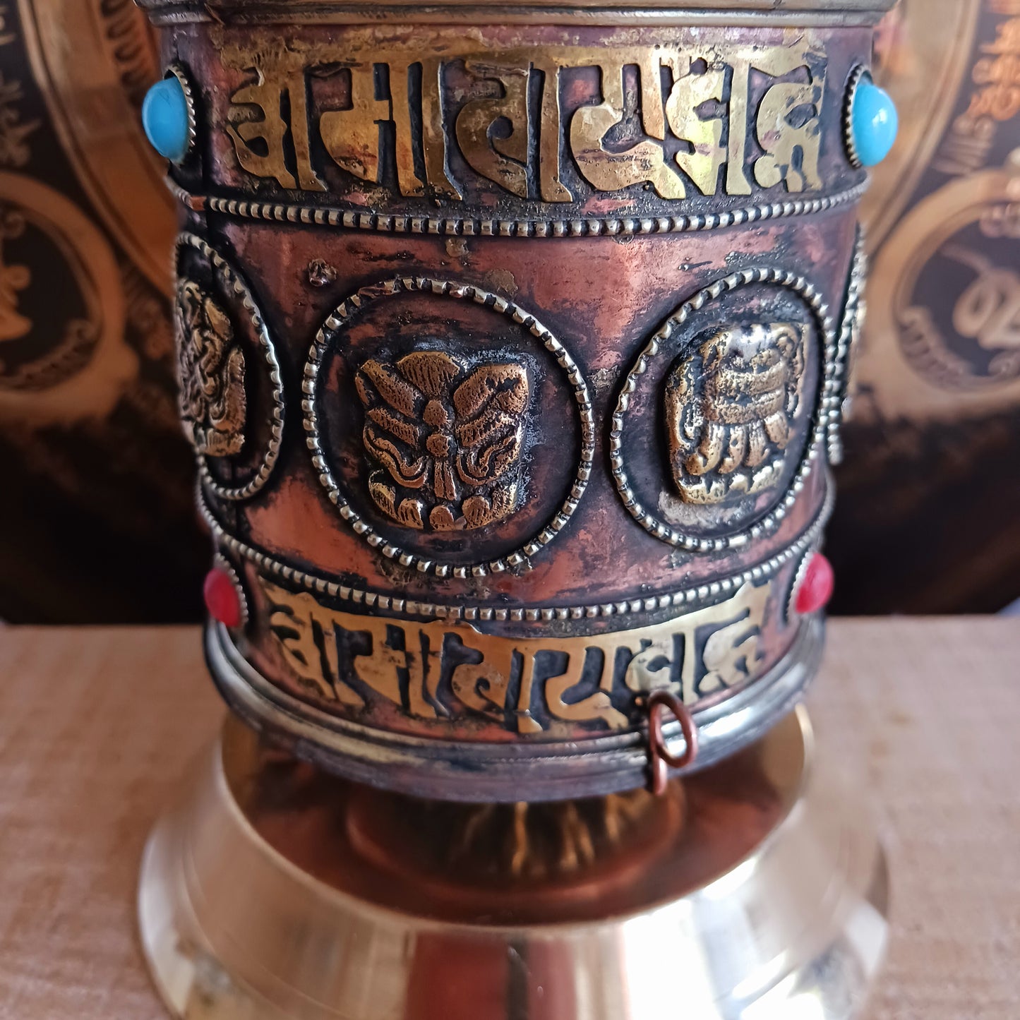 Invite blessings, clarity, and compassion into your space with this handcrafted metal table-top prayer wheel. Beautifully adorned with the Eight Auspicious Symbols, this sacred piece is both a devotional object and a stunning piece of spiritual art.