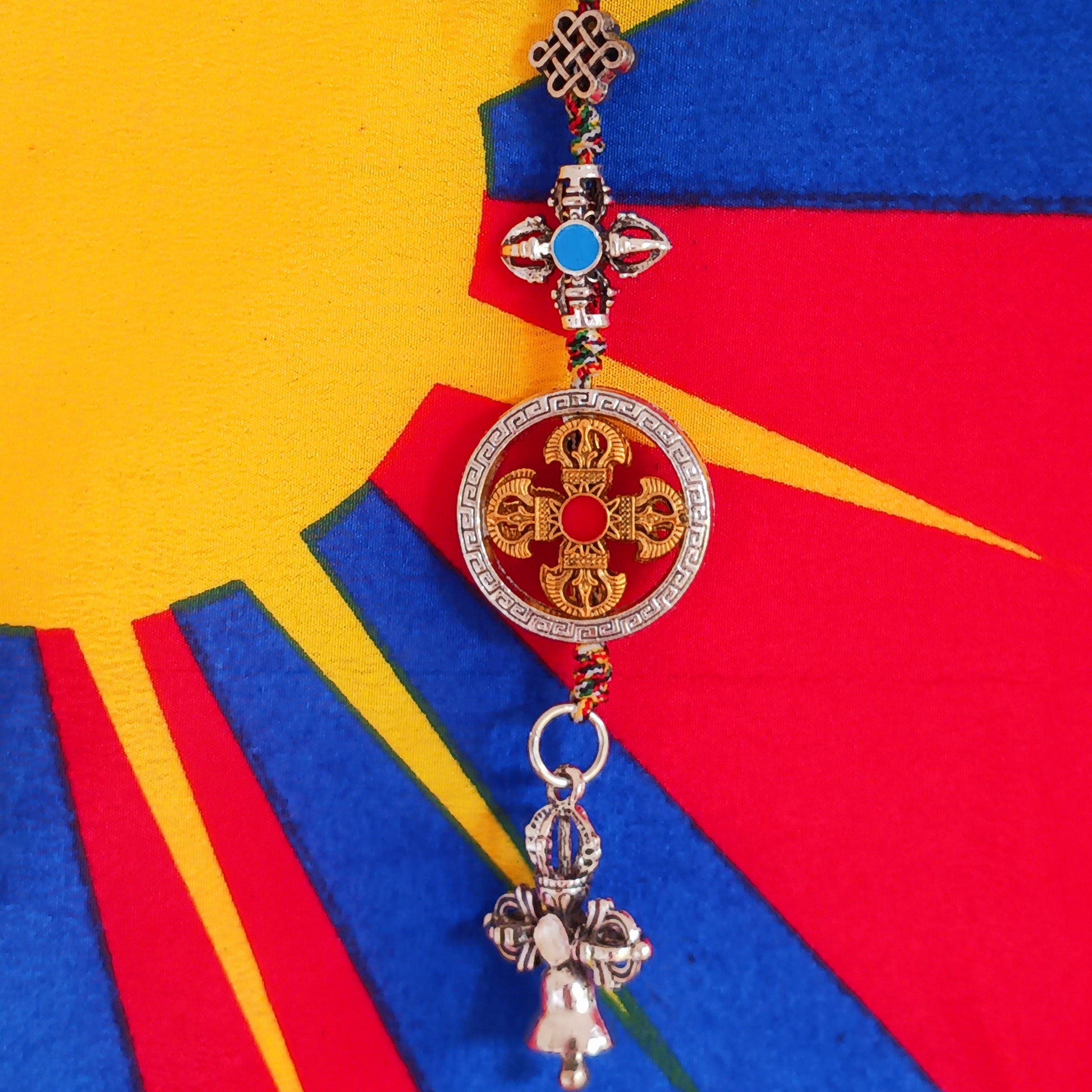 Bring peace, protection, and wisdom wherever you go with this handcrafted Buddhist protective pendant. Featuring the powerful Double Dorje, a symbol of stability and fearlessness, and the Bell, representing wisdom and the understanding of emptiness, this sacred charm is ideal for your car, home, bag, or key ring. Whether you're seeking spiritual grounding or a meaningful gift, this pendant serves as a constant reminder of balance and enlightenment in daily life.