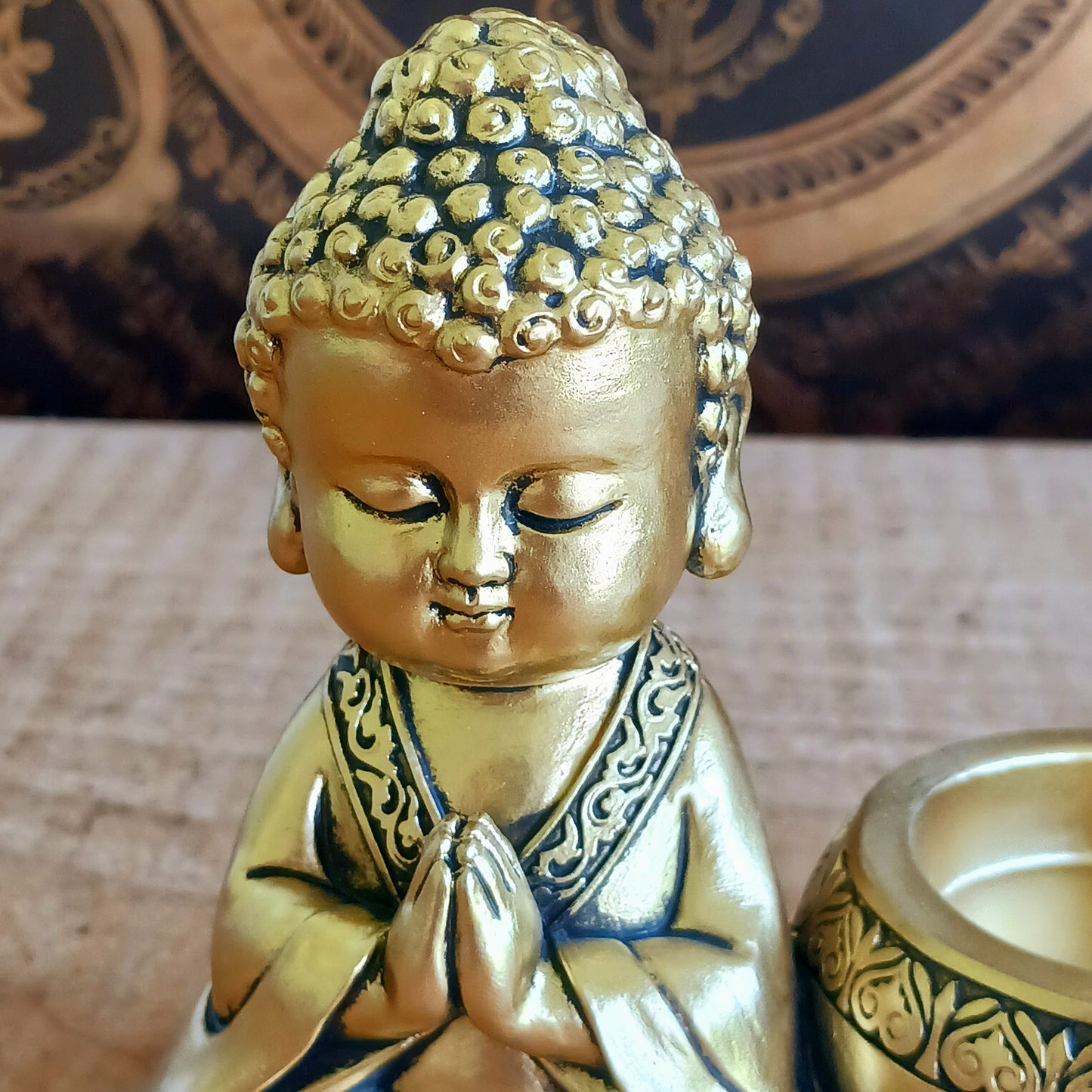 Bring a sense of peace and mindfulness into your home with this elegant Gold Buddha Tealight Candle Holder. Featuring a beautifully crafted praying Buddha figure alongside a tealight holder, this decorative piece creates a calming ambiance wherever it is placed.