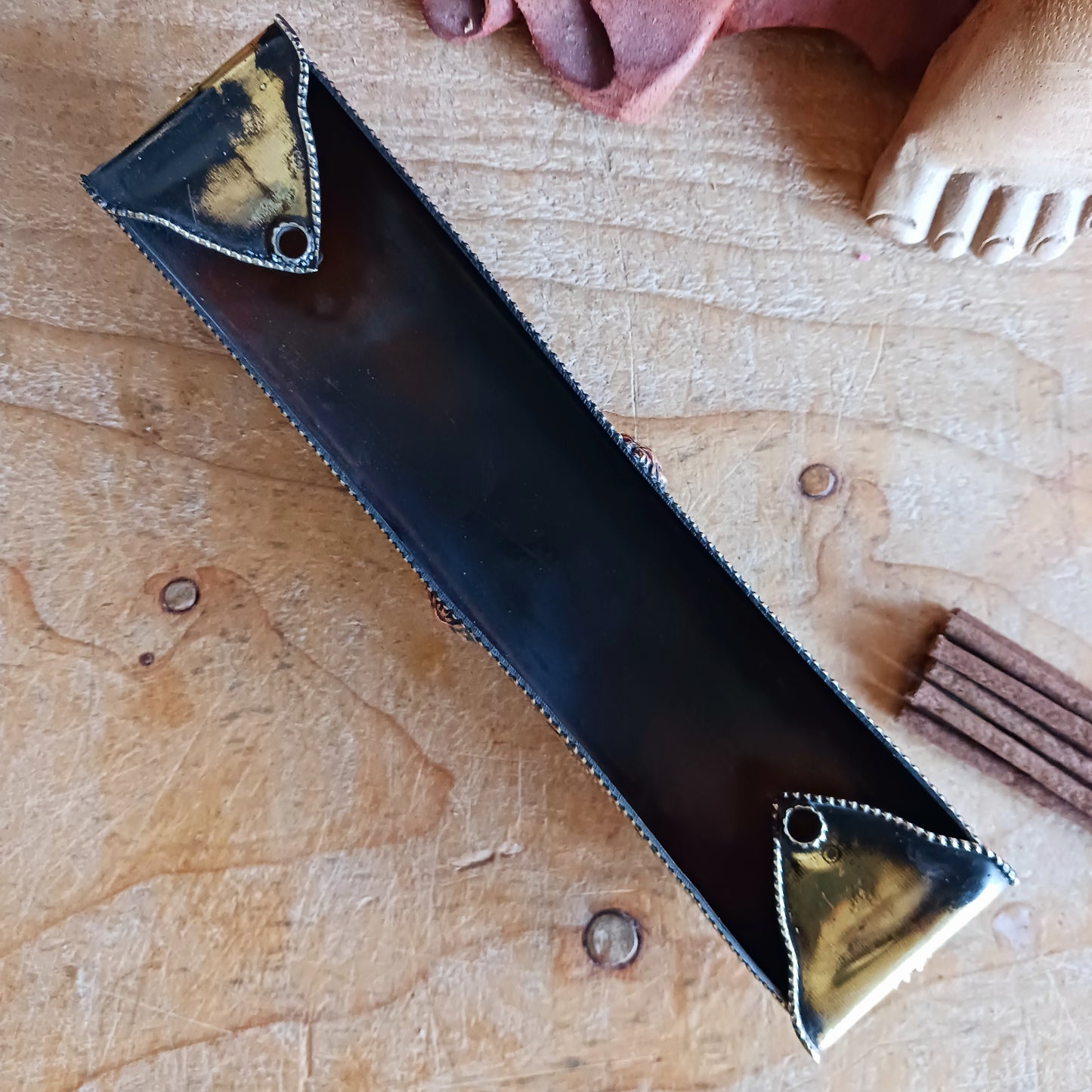 Elevate your sacred space with this traditional copper and brass incense burner, crafted with authentic Tibetan design elements. Supported by small raised feet, it provides excellent airflow for clean, even burning.