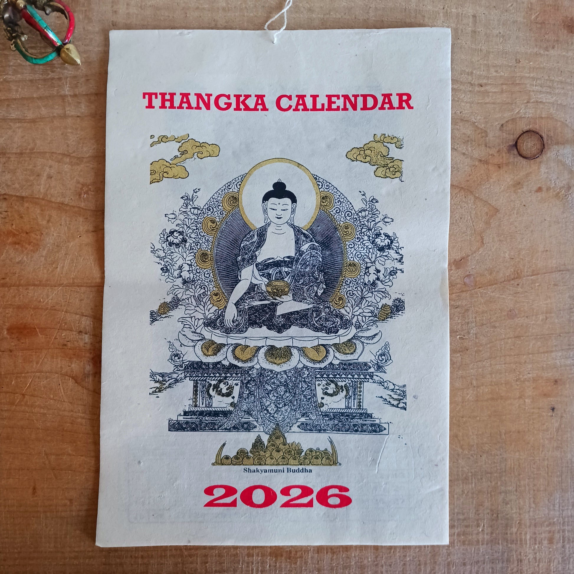 Bring the beauty, wisdom, and serenity of Buddhist art into your home with this handmade Lokta paper wall calendar, featuring seven revered Buddhist deities illustrated in traditional Thangka style. Each page showcases one of the following sacred figures: