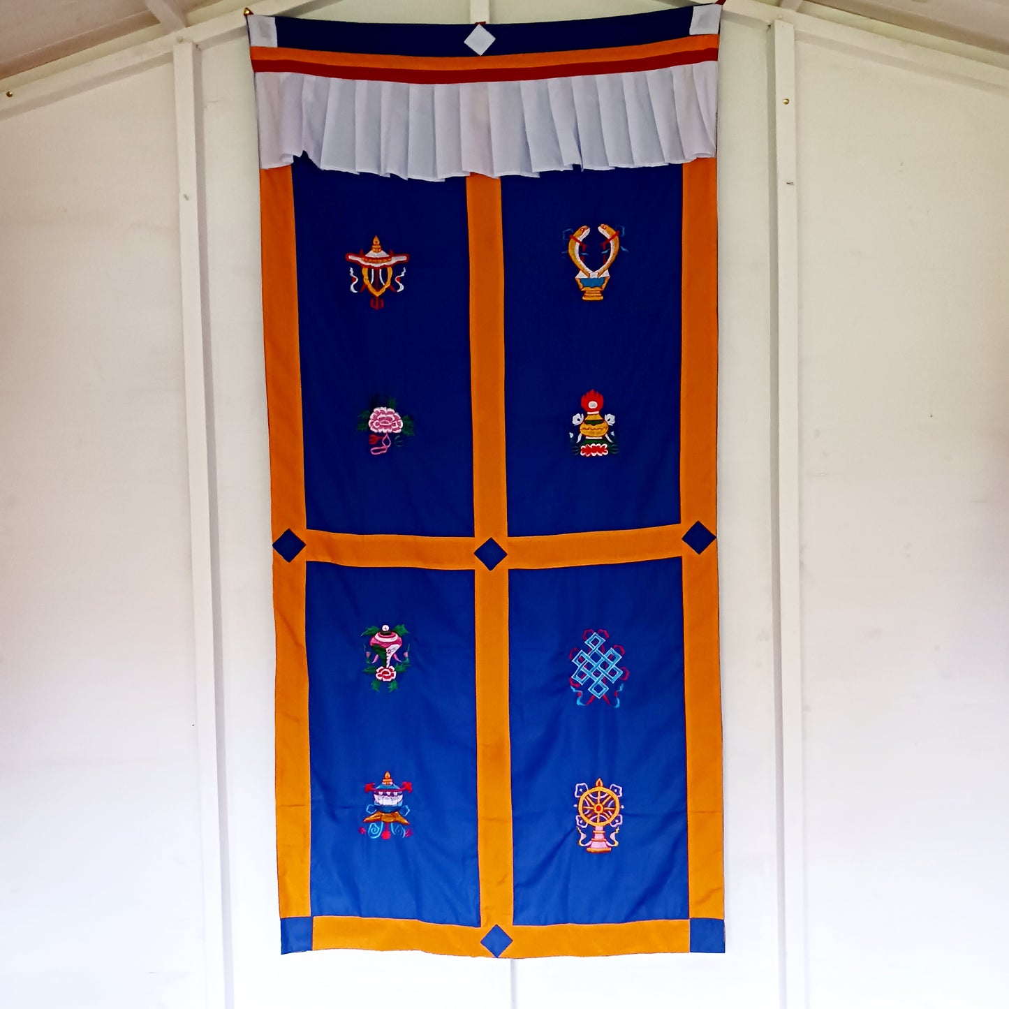 Bring harmony, beauty, and traditional craftsmanship into your space with this hand-embroidered Tibetan Buddhist door curtain, adorned with the sacred Eight Auspicious Symbols, also known as The Eight Jewels. Each symbol is intricately stitched to represent blessings of prosperity, protection, wisdom, and spiritual awakening.