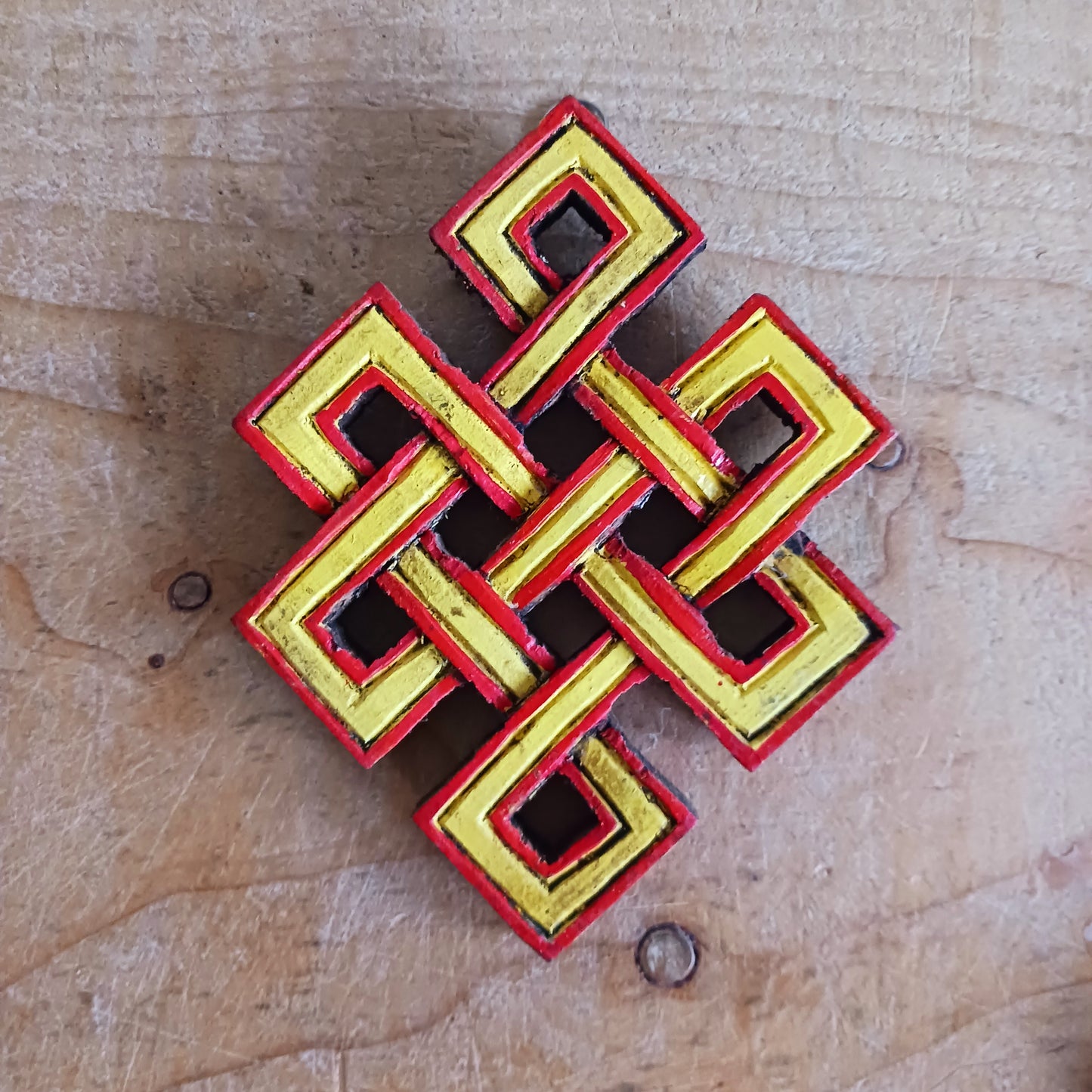 The Eternal (or Endless) Knot is one of the Eight auspicious symbols in Tibetan Buddhism. Because the knot has no beginning and no end, the eternal knot symbolizes the endless wisdom and compassion of the Buddha.